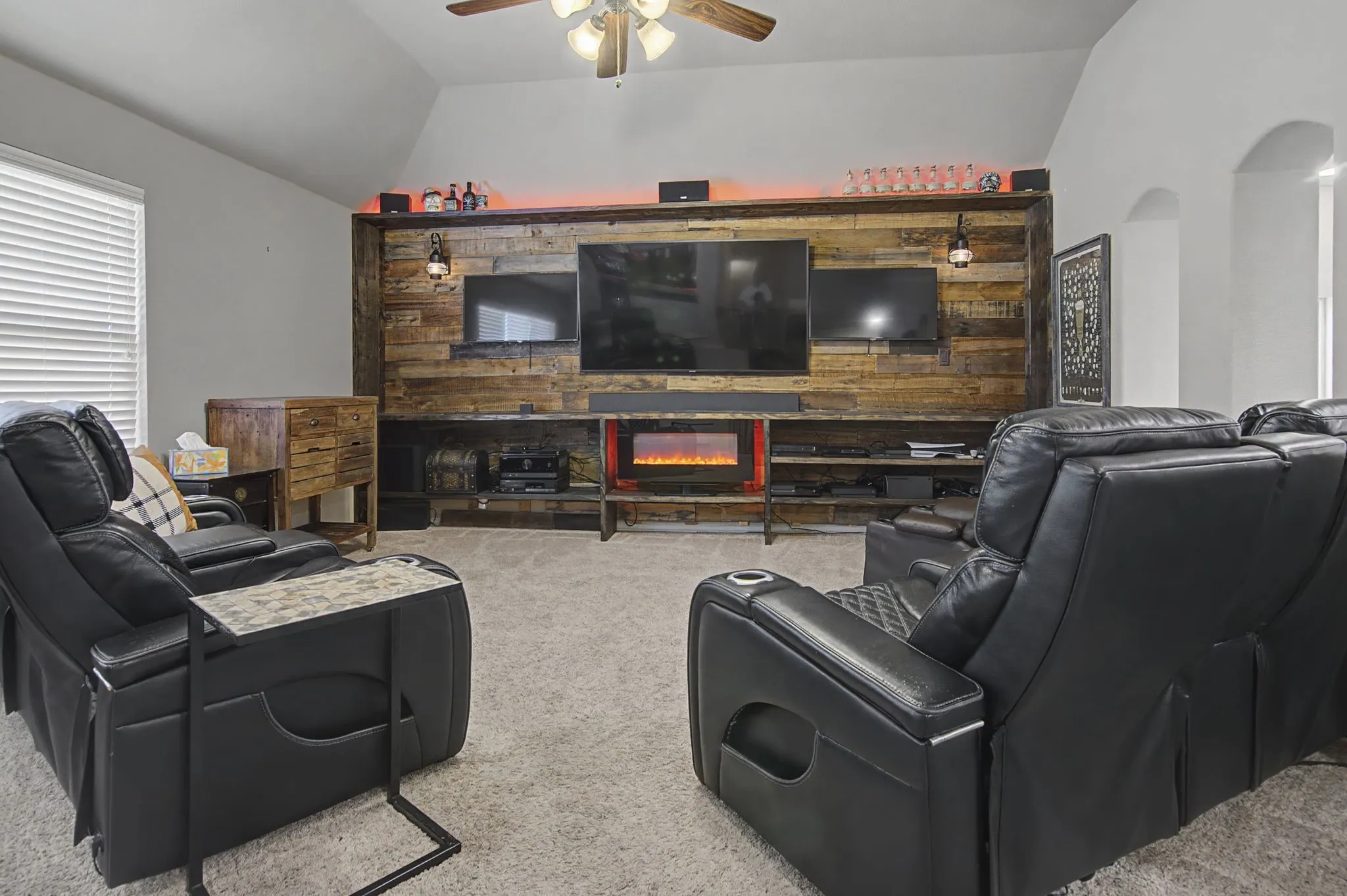 Upstairs living space.  A built-in entertainment center.  As shown it can hold 3 tv's for the sports enthusiast! Shelves for storage, electric fireplace and custom lighting.