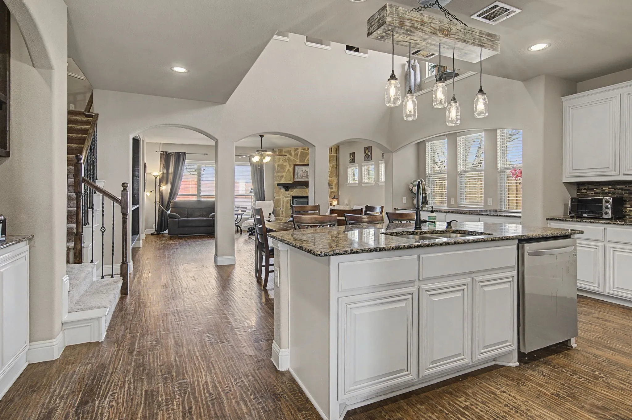 Kitchen has a large center island with seating. This home has room for entertaining a crowd or just the right floor plan to keep the day-to-day life together in the open concept arrangement.