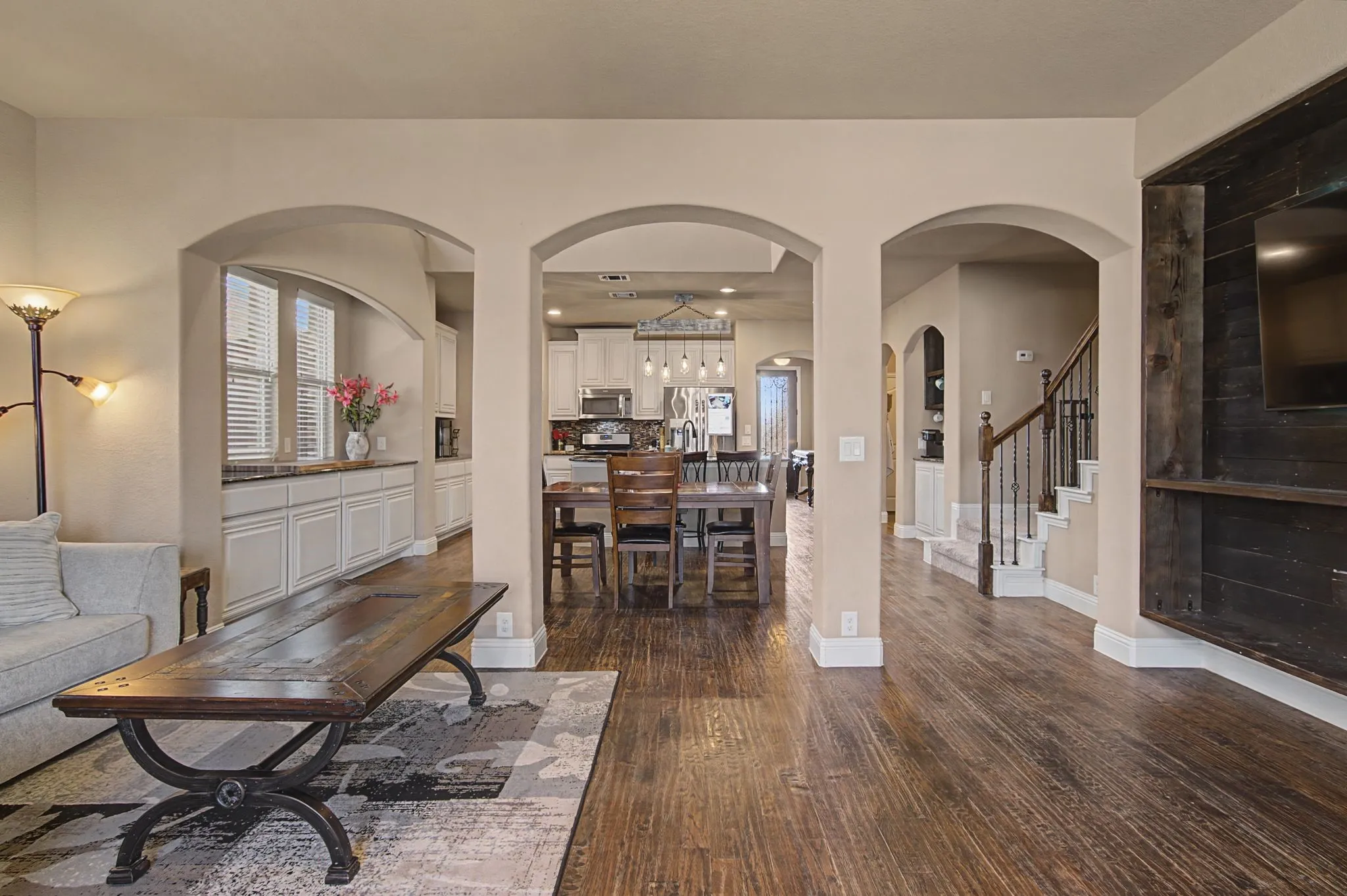 To the right is the built-in stained entertainment area for tv and decor. It coordinates with the coffee bar in the kitchen area.