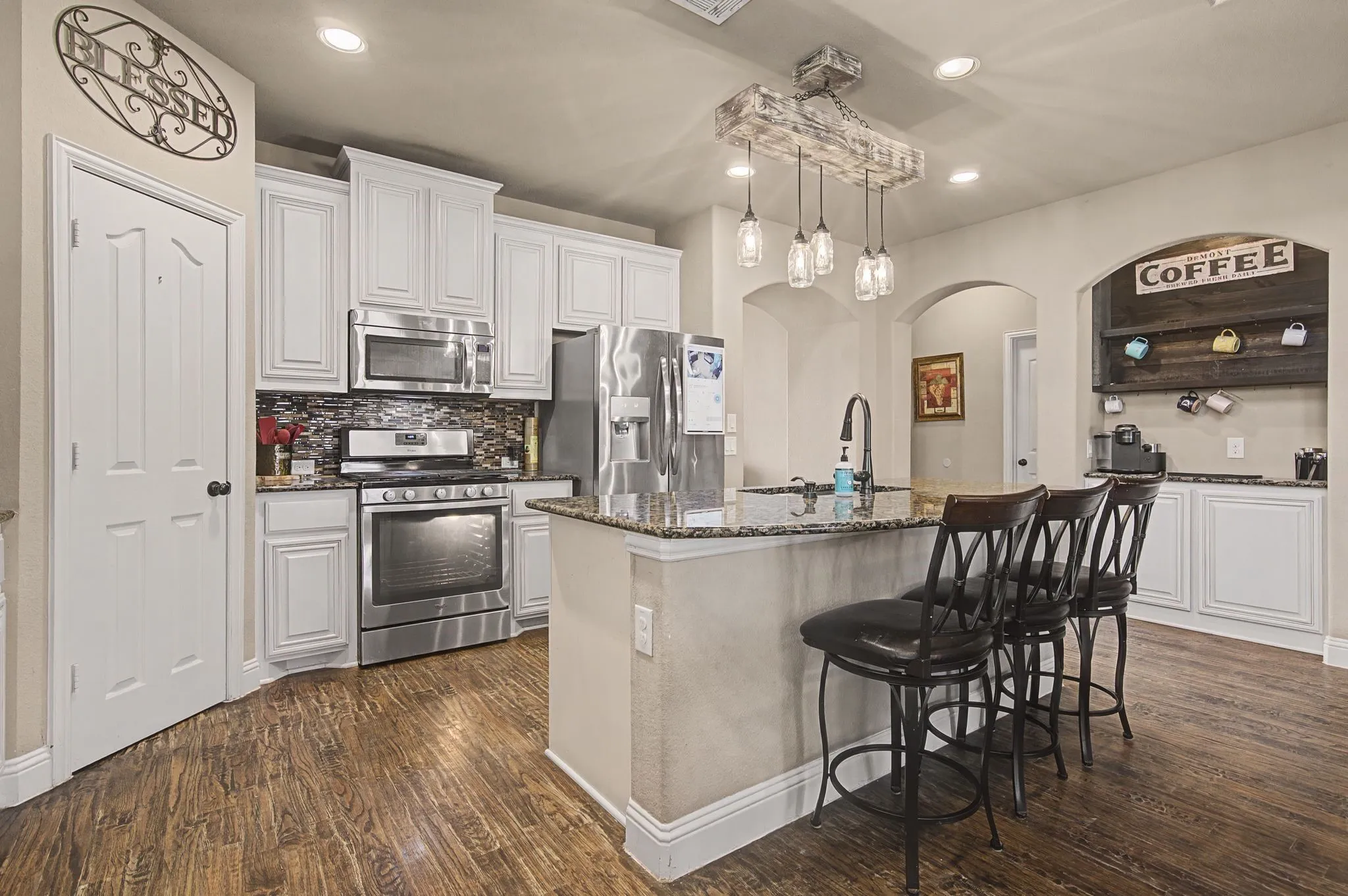 The storage and space in this kitchen is amazing.  The coffee bar added to the niche with storage is perfect!