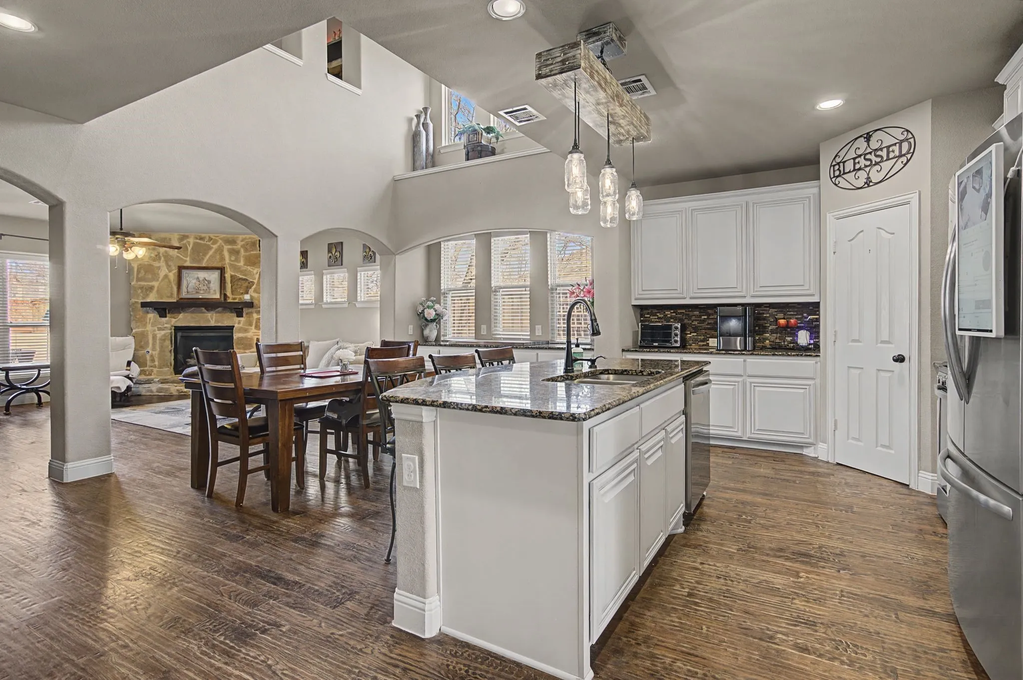 A view of the spacious open concept living, dining and kitchen area.  Tons of counter space and storage. No shortage of windows to allow natural lighting