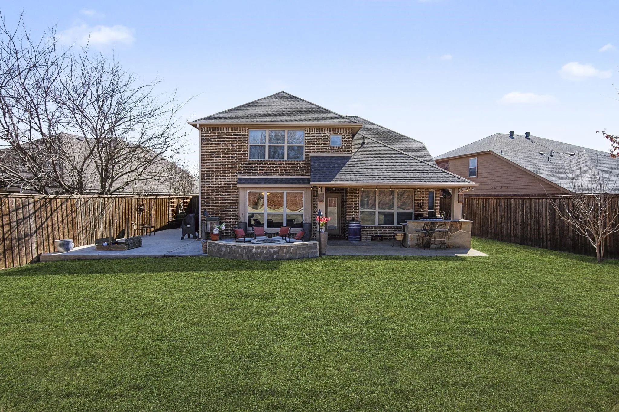 Look at the size of your backyard! Plenty of room to enjoy grilling, kids, pets and gardening.  Extended height of board on board fence on the sides and no neighbors behind the home for enjoying all the privacy of your backyard. Photo has been digitally updated to include green grass