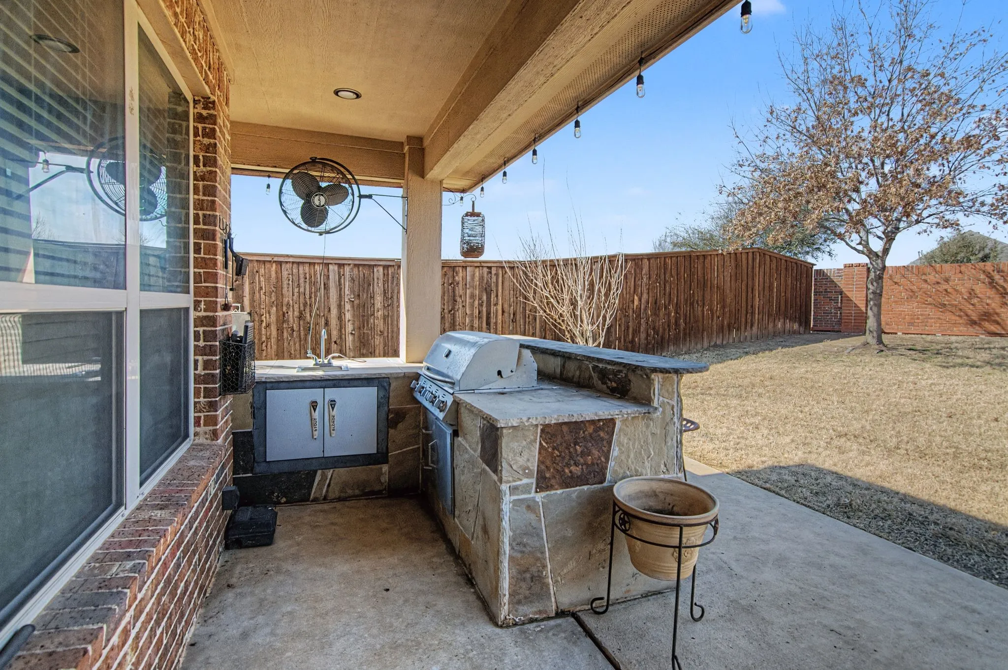 Covered patio area with kitchen, grilling area