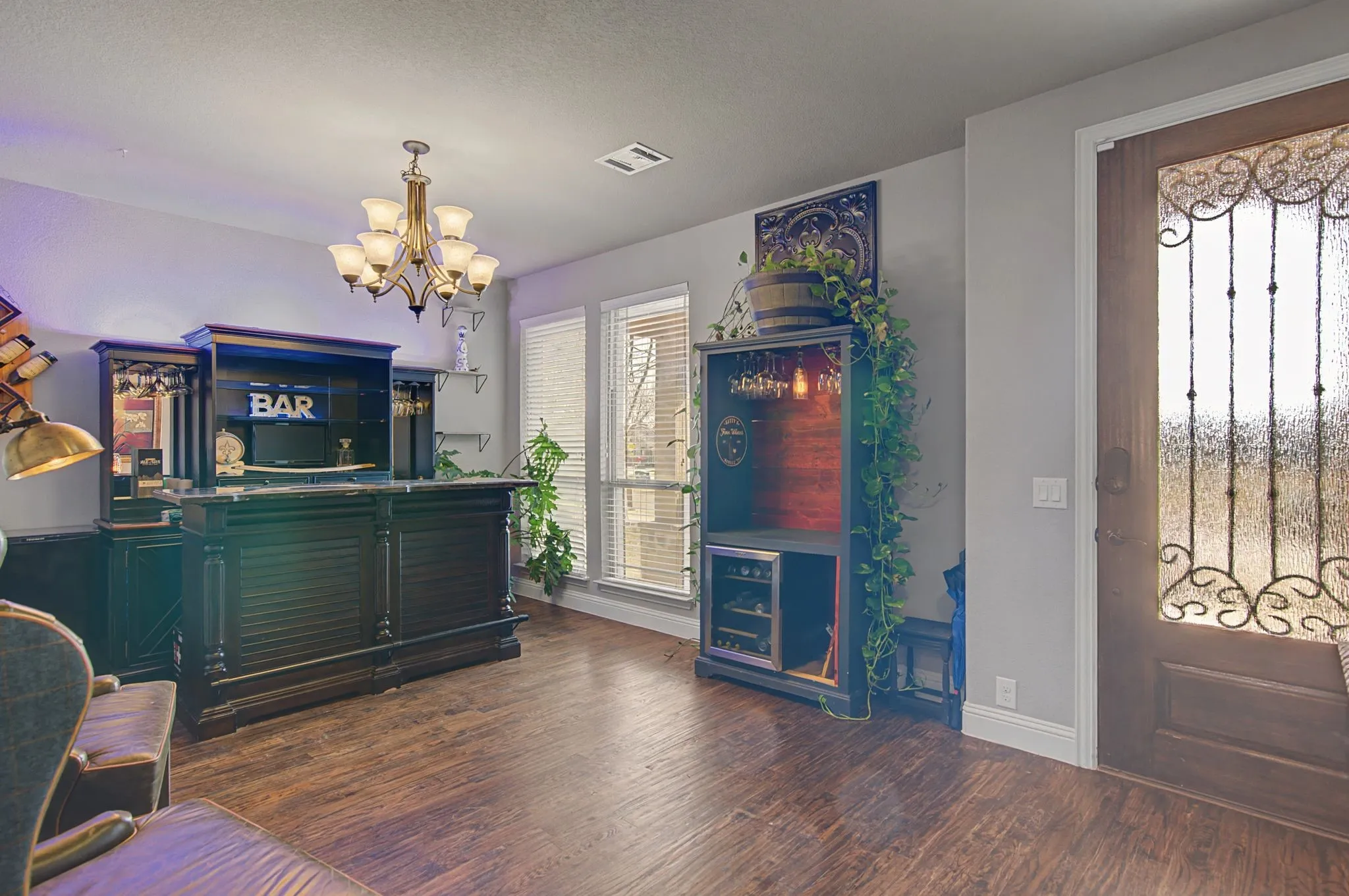 Looking back at the front door and the view to the covered front porch area.  This space is large and will accommodate your formal dining furniture or large office area.