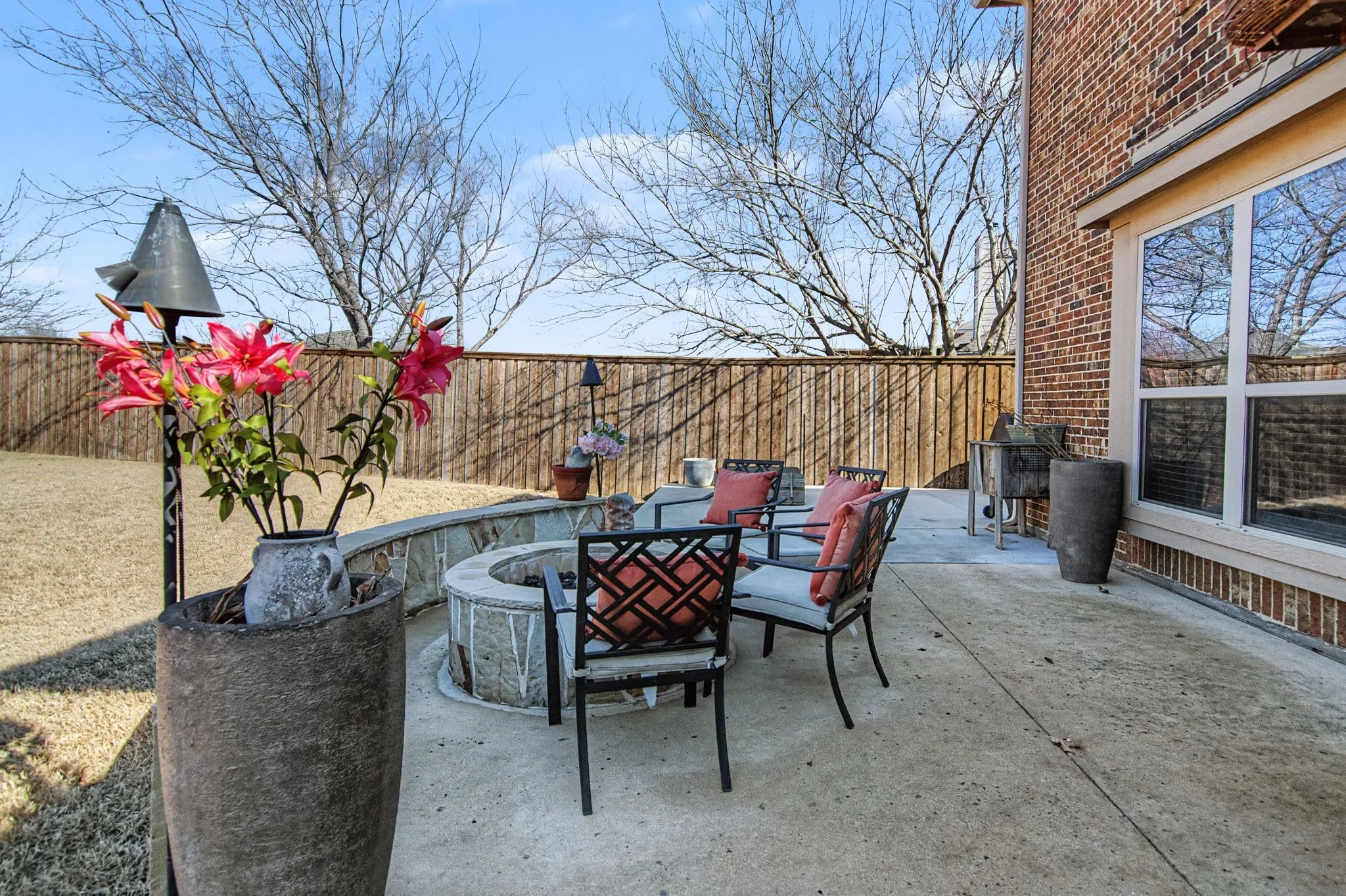 The open patio area with fire pit area.  Extended beyond and along the side of the home for extra patio area.
