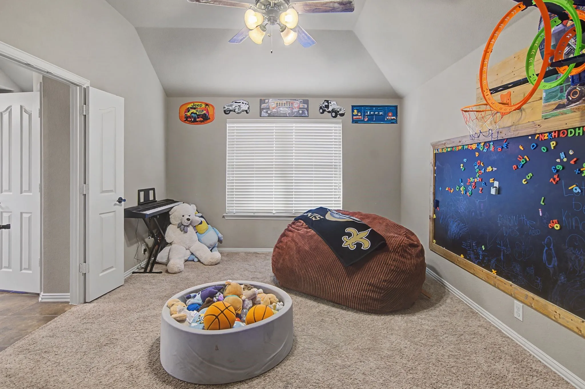 One of the upstairs bedrooms with an ensuite bath.  Perfect for a 2nd primary, guest room with private bath, etc.  Currently used for a playroom for the kiddos, perfect!