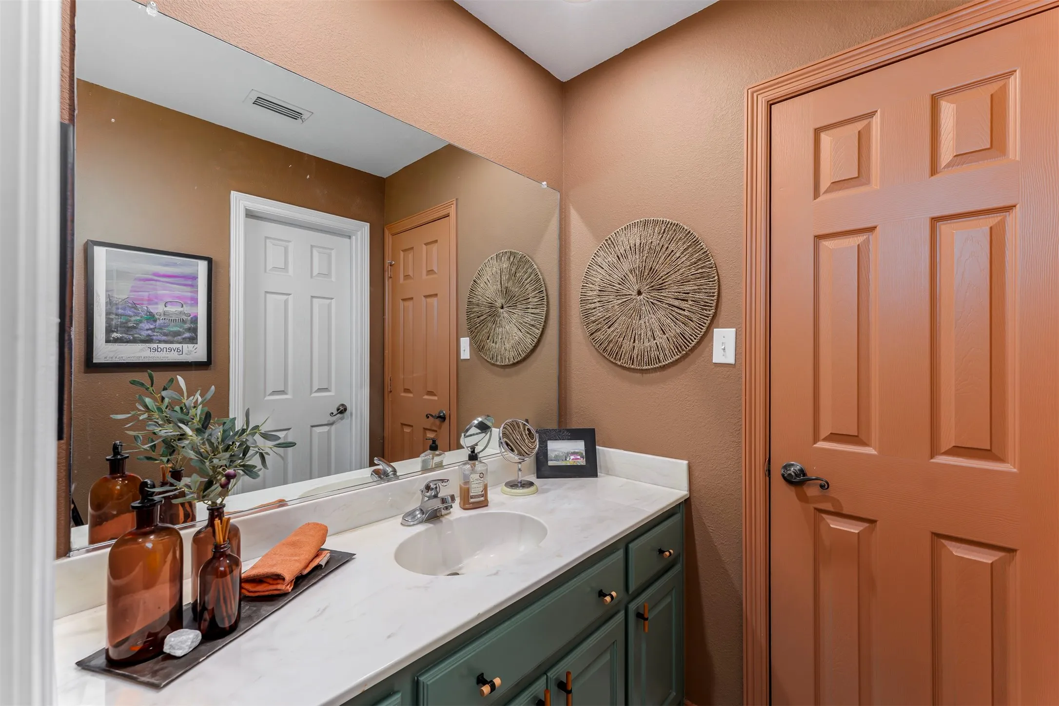 Integrated vanity with a single basin sink, polished chrome faucet, and white countertop