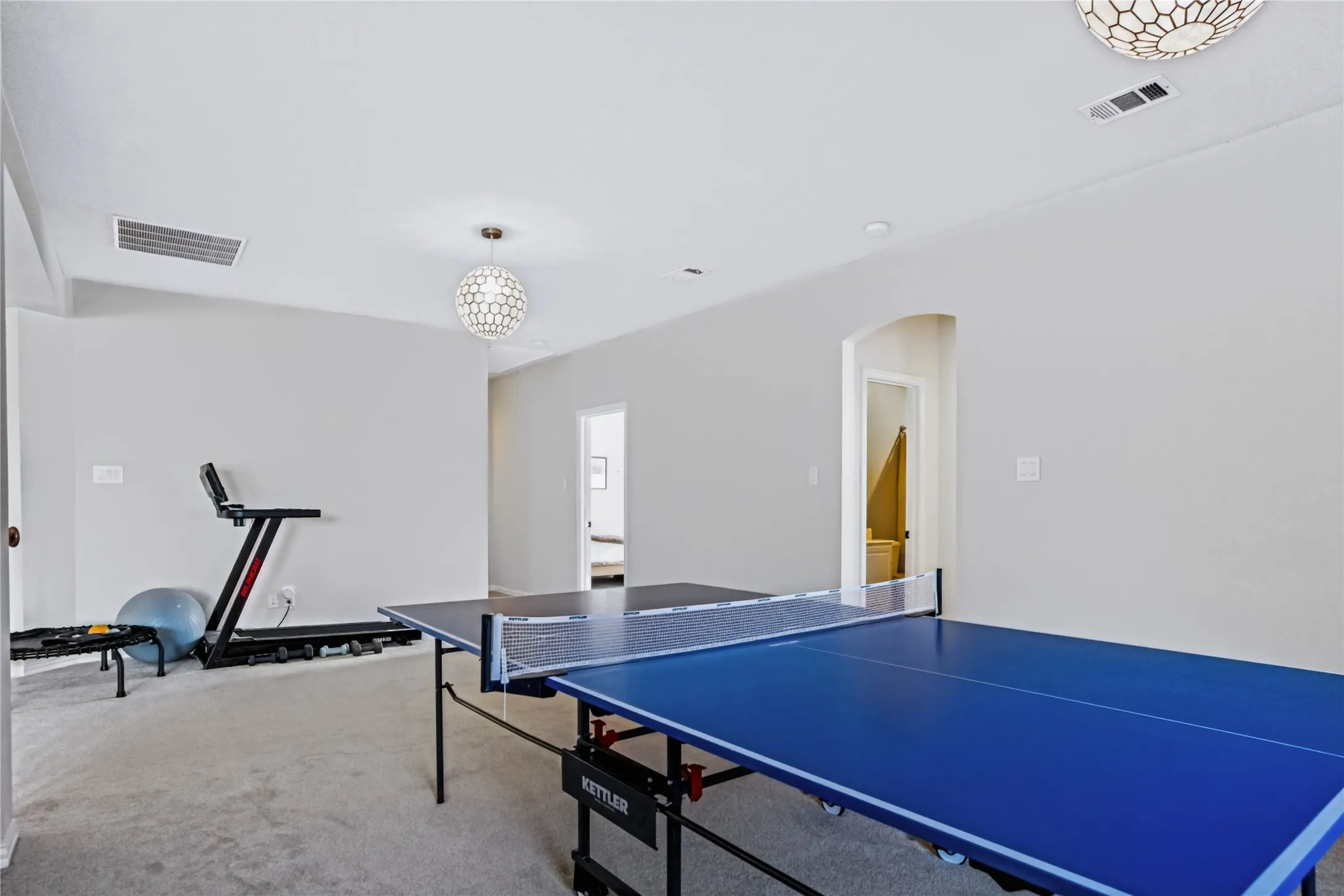 Recessed lighting, arched doorway, and two decorative ceiling light fixtures