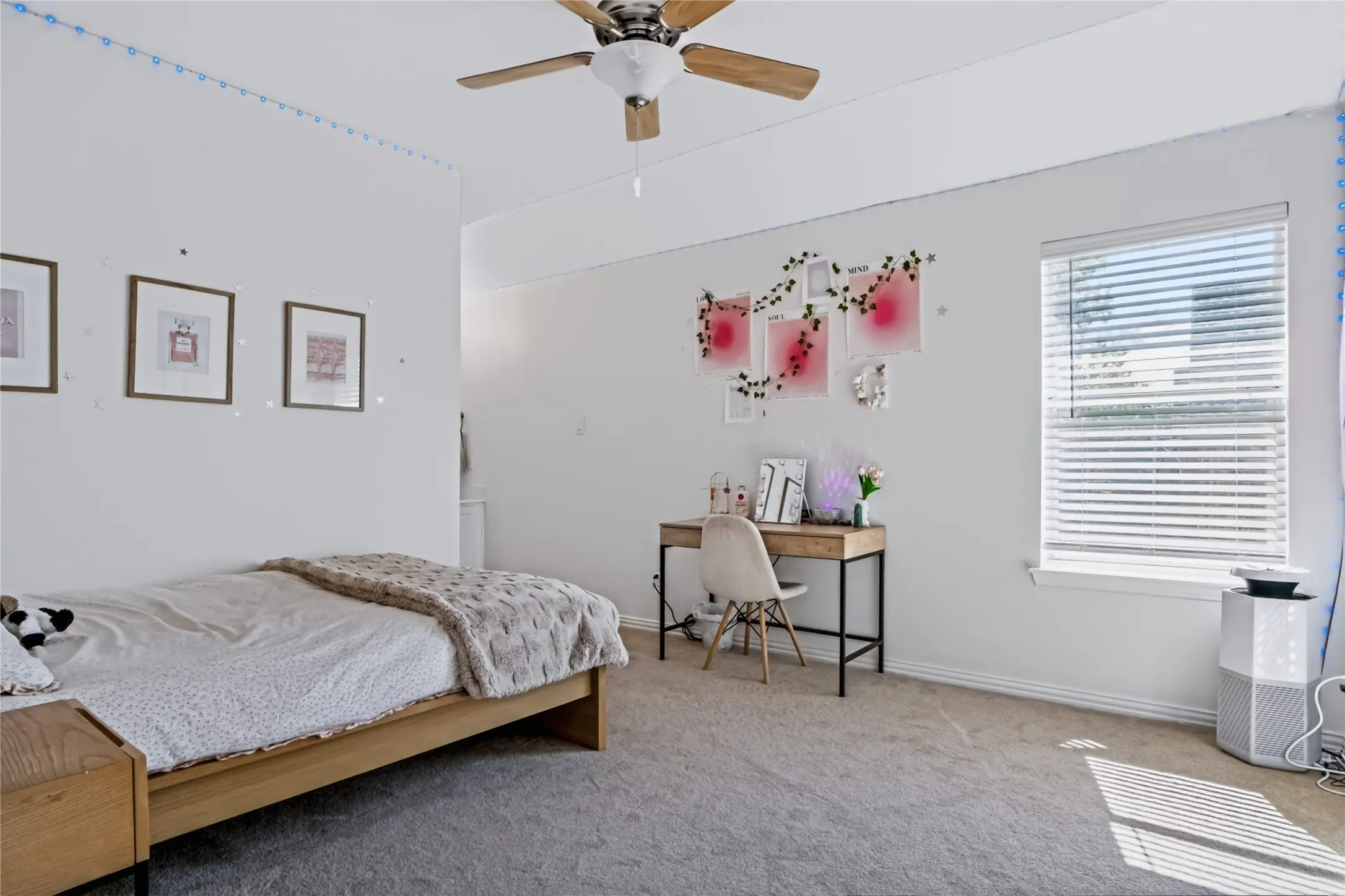 Wall-to-wall carpeting and a ceiling fan with integrated lighting