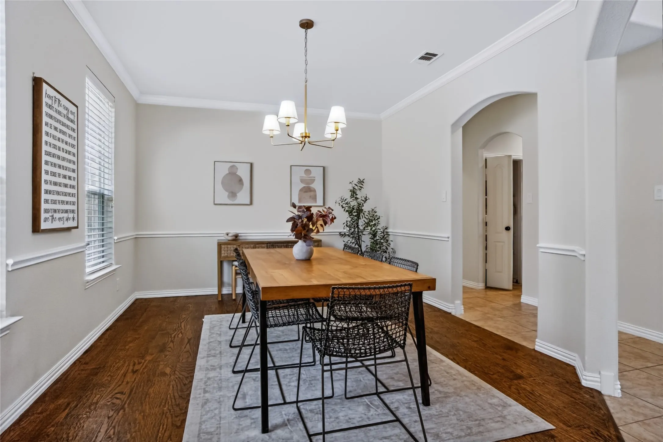 Wood-finish flooring, crown molding, and wainscoting details
