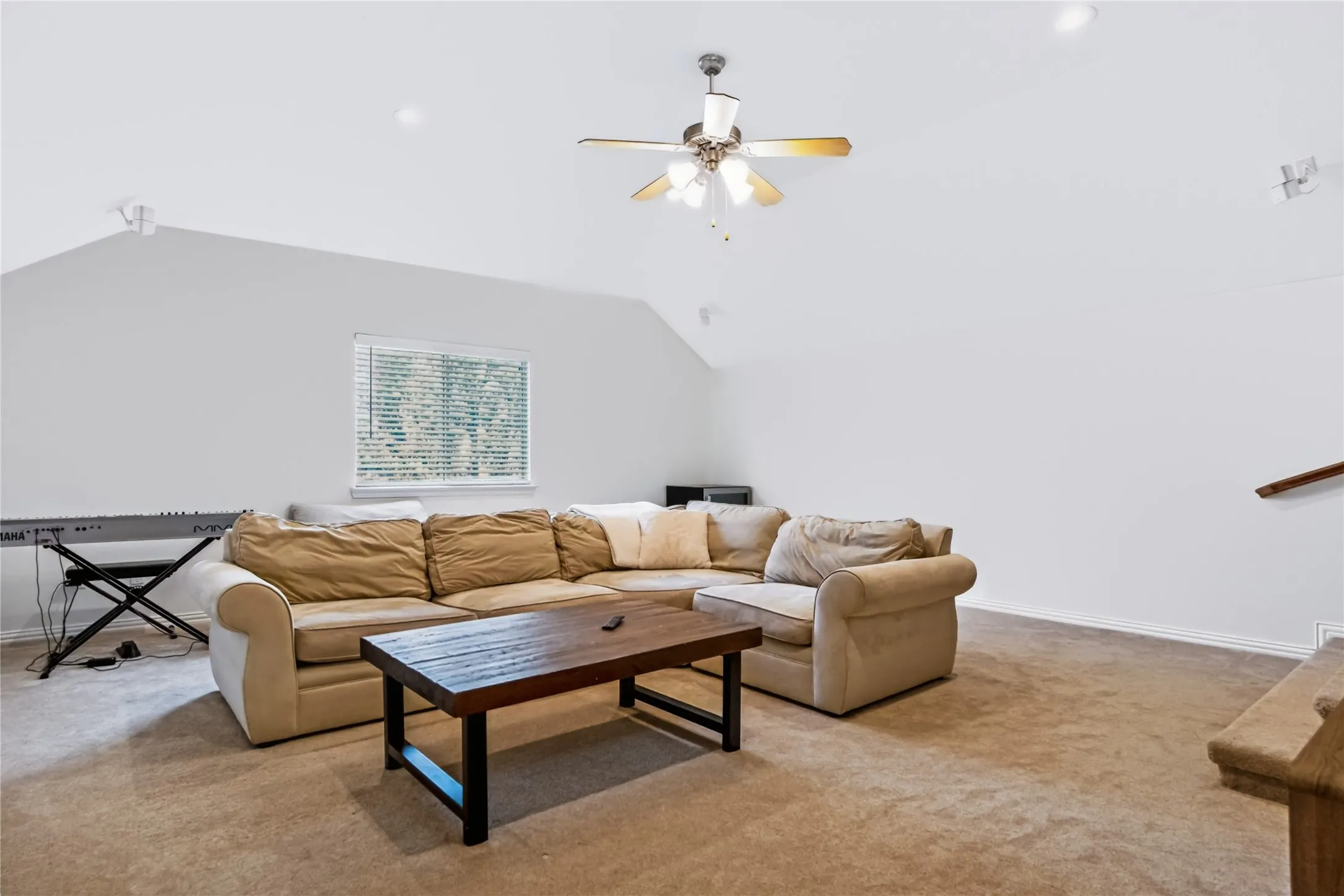 Vaulted ceiling with a ceiling fan, recessed lighting, and carpet flooring