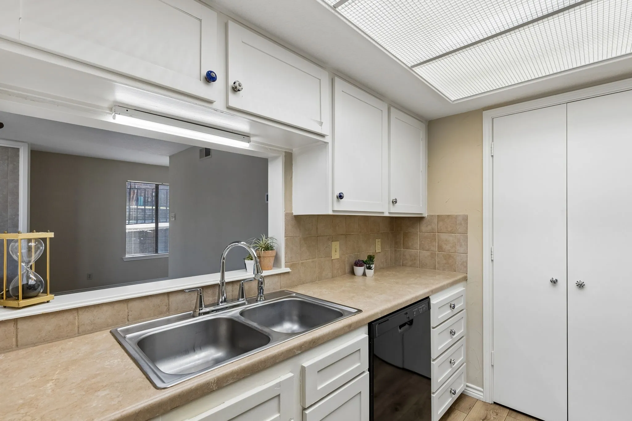The galley kitchen has a pass through to the living room