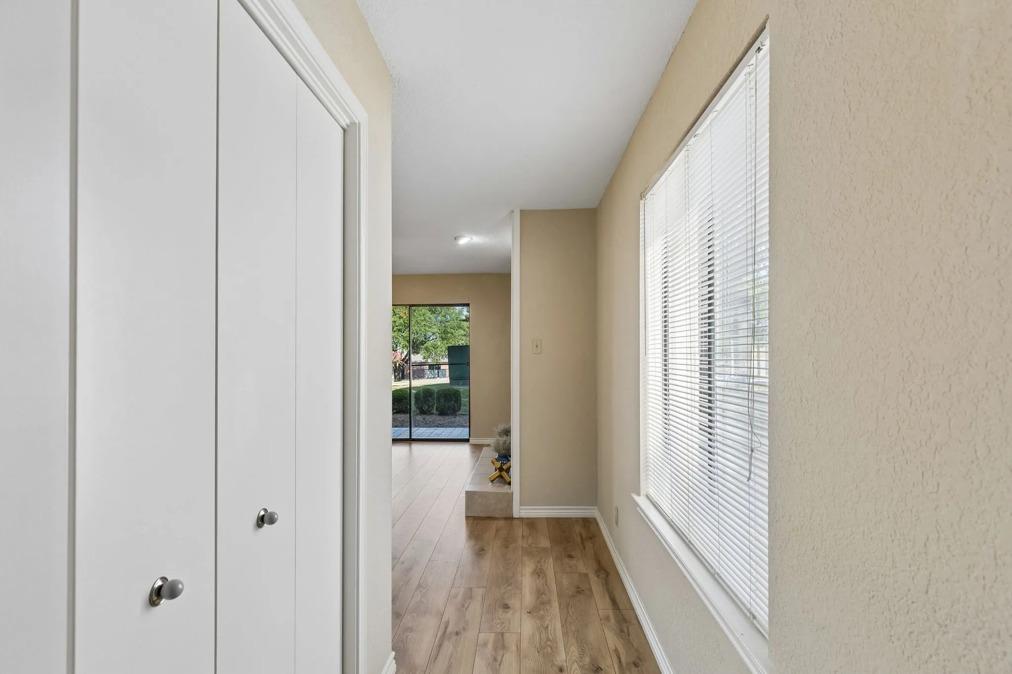 Bright hallway featuring closet storage as you enter the home