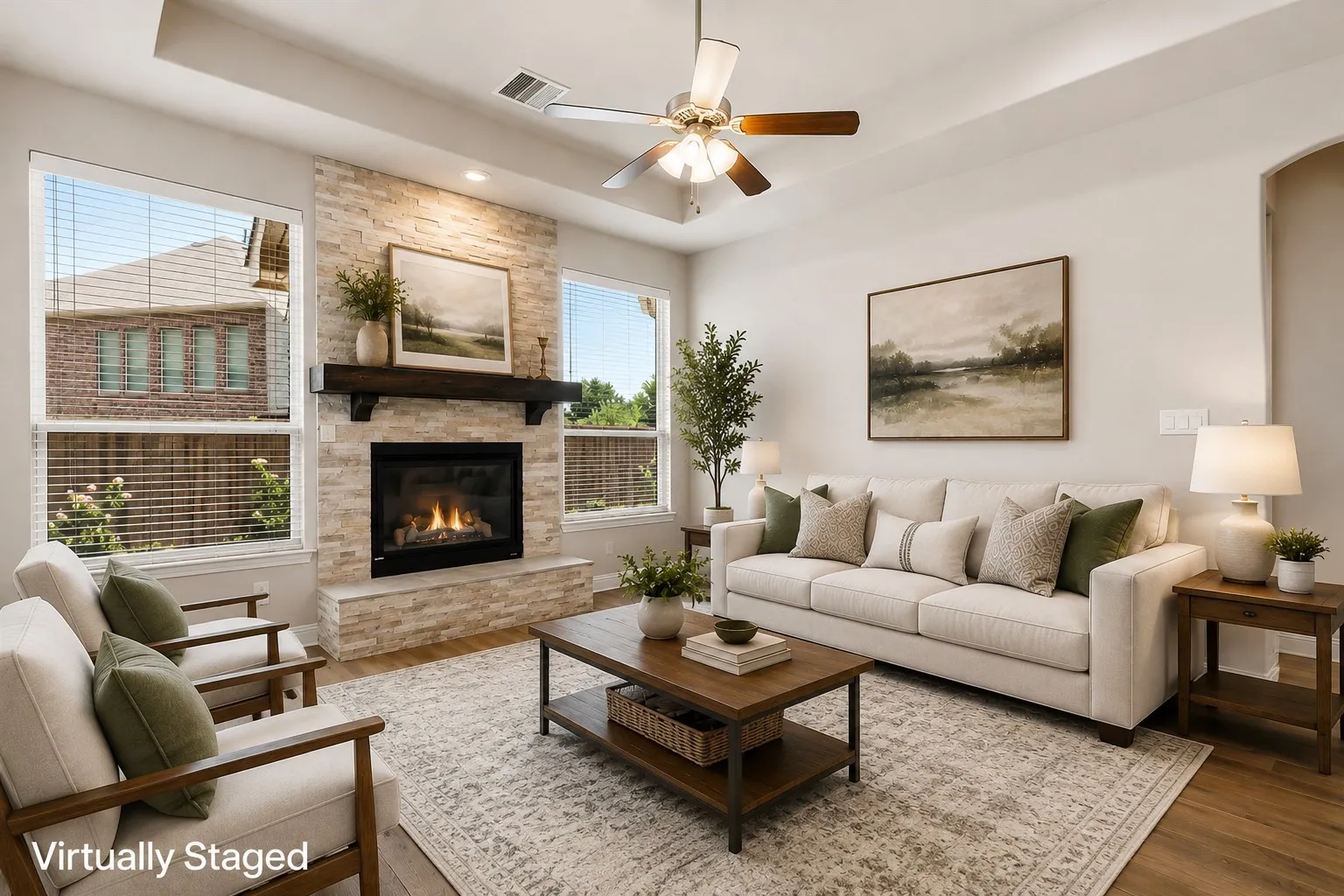 Living area featuring a stone-clad fireplace with a wood mantel, wood-finish flooring, a ceiling fan, and recessed lighting