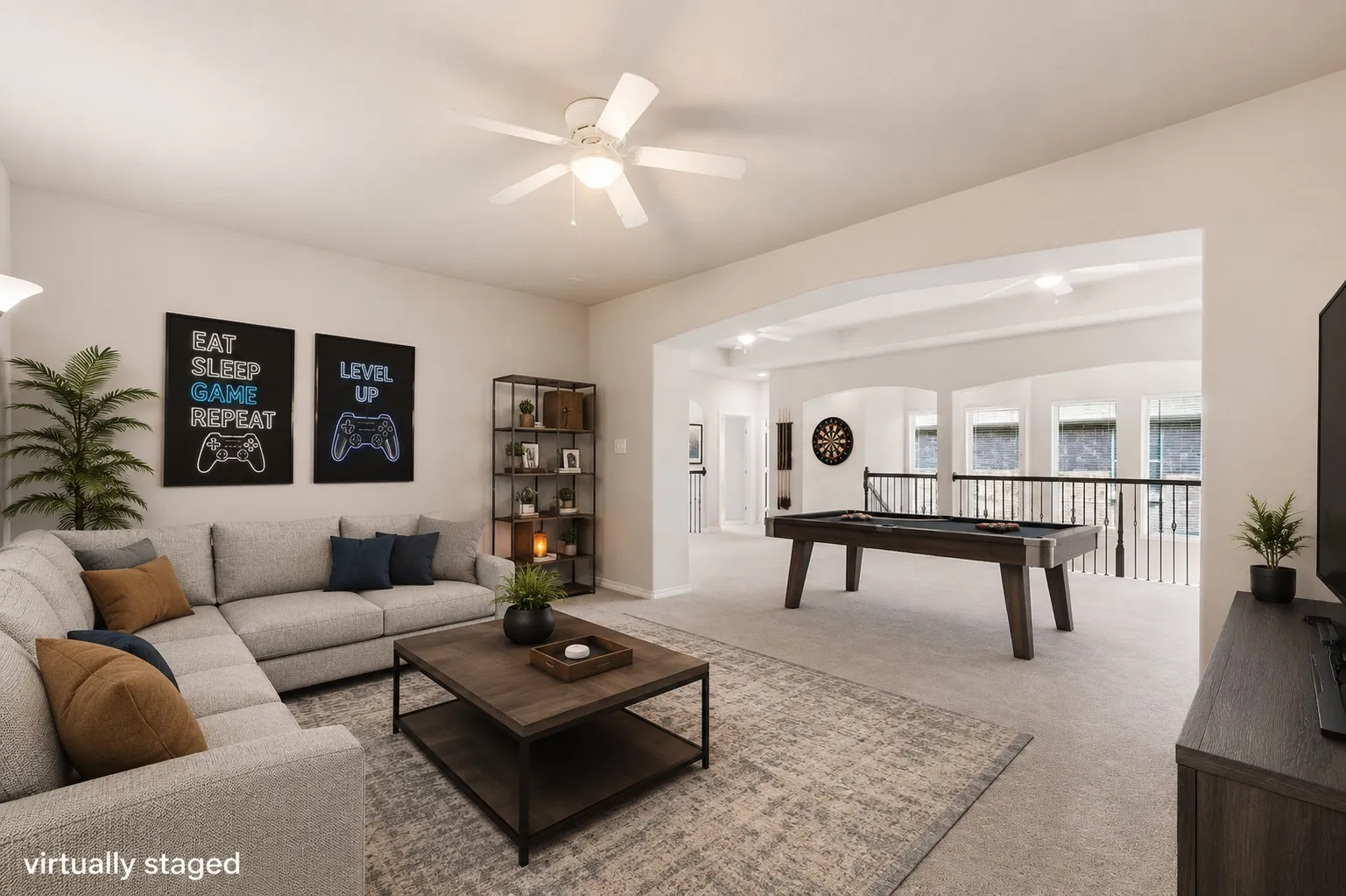 Spacious bonus room featuring a built-in pool table, vaulted ceilings, and an open railing overlooking the lower level