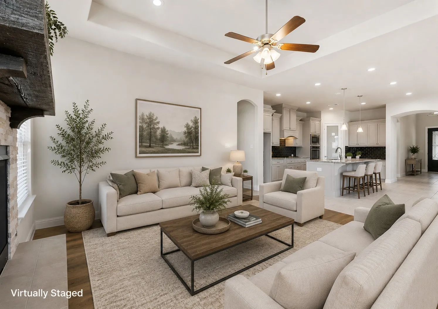 Open-concept living area featuring a tray ceiling, recessed lighting, and wood-finish flooring