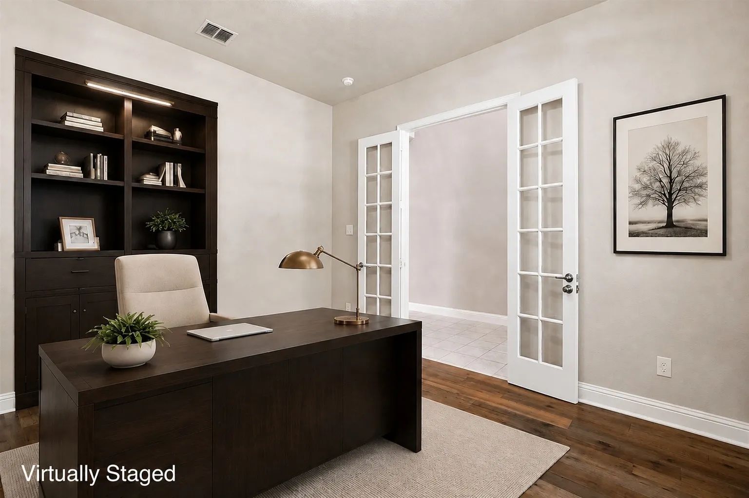 Built-in dark wood cabinetry with integrated lighting, wood-finish flooring, and double French doors with glass panes