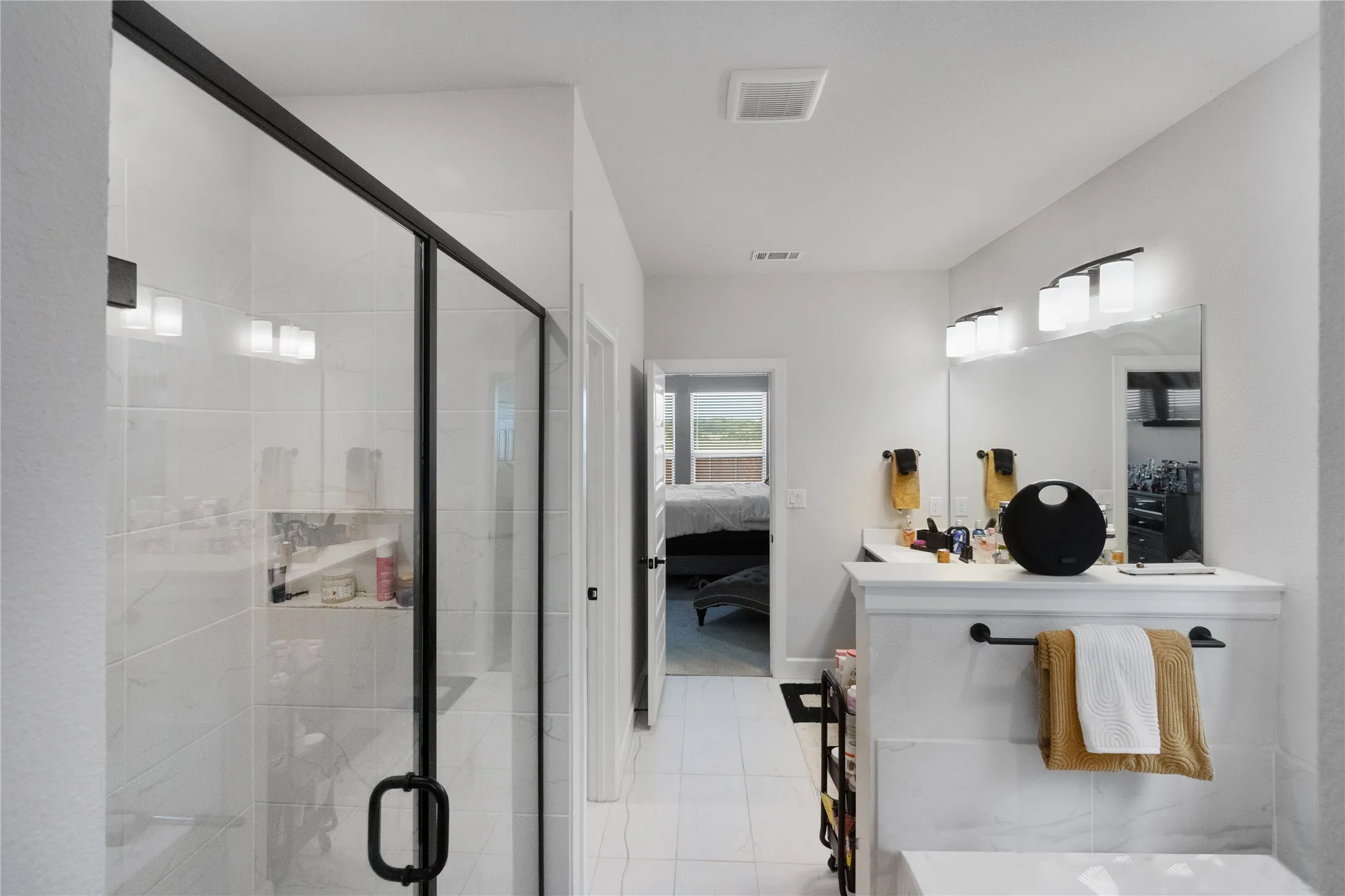 Walk-in shower with black-framed glass enclosure