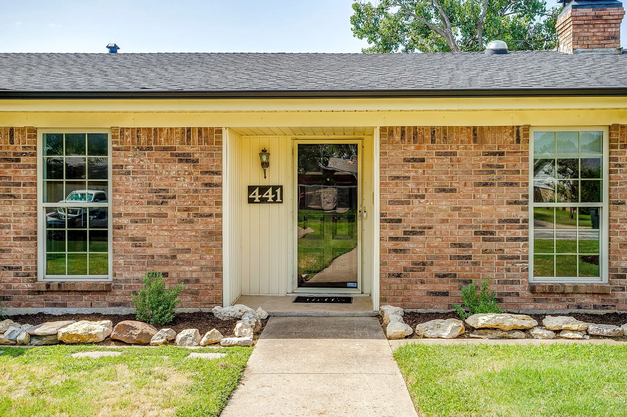 Brick exterior with a shingled roof