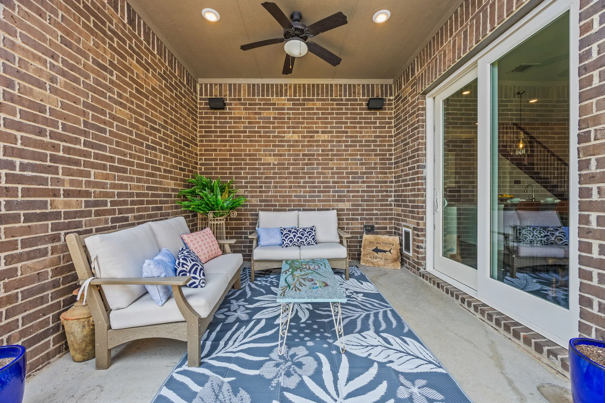 Covered patio with fan, lighting, and a gas stub