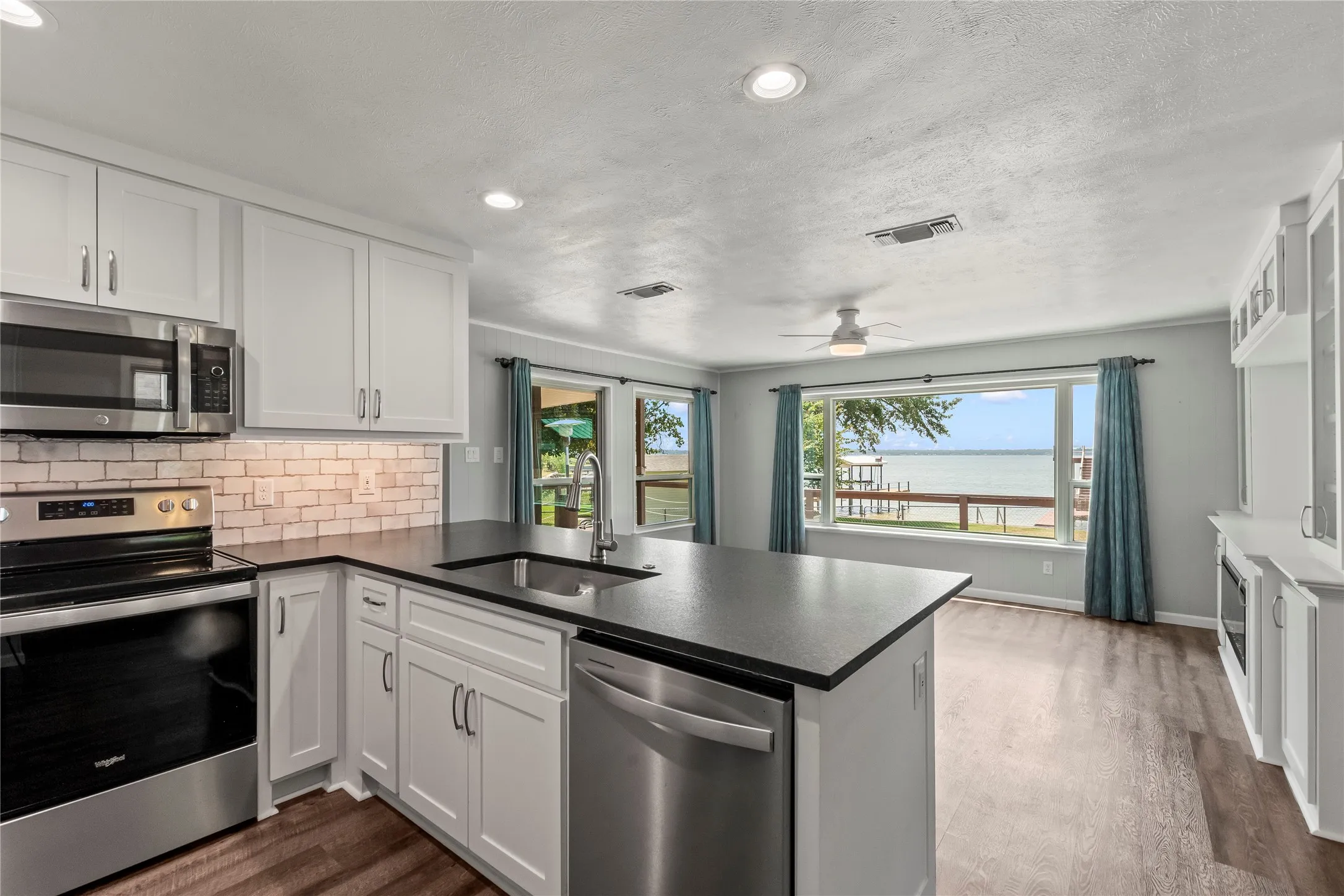 Expansive windows in the living area frame fabulous water views from the kitchen.