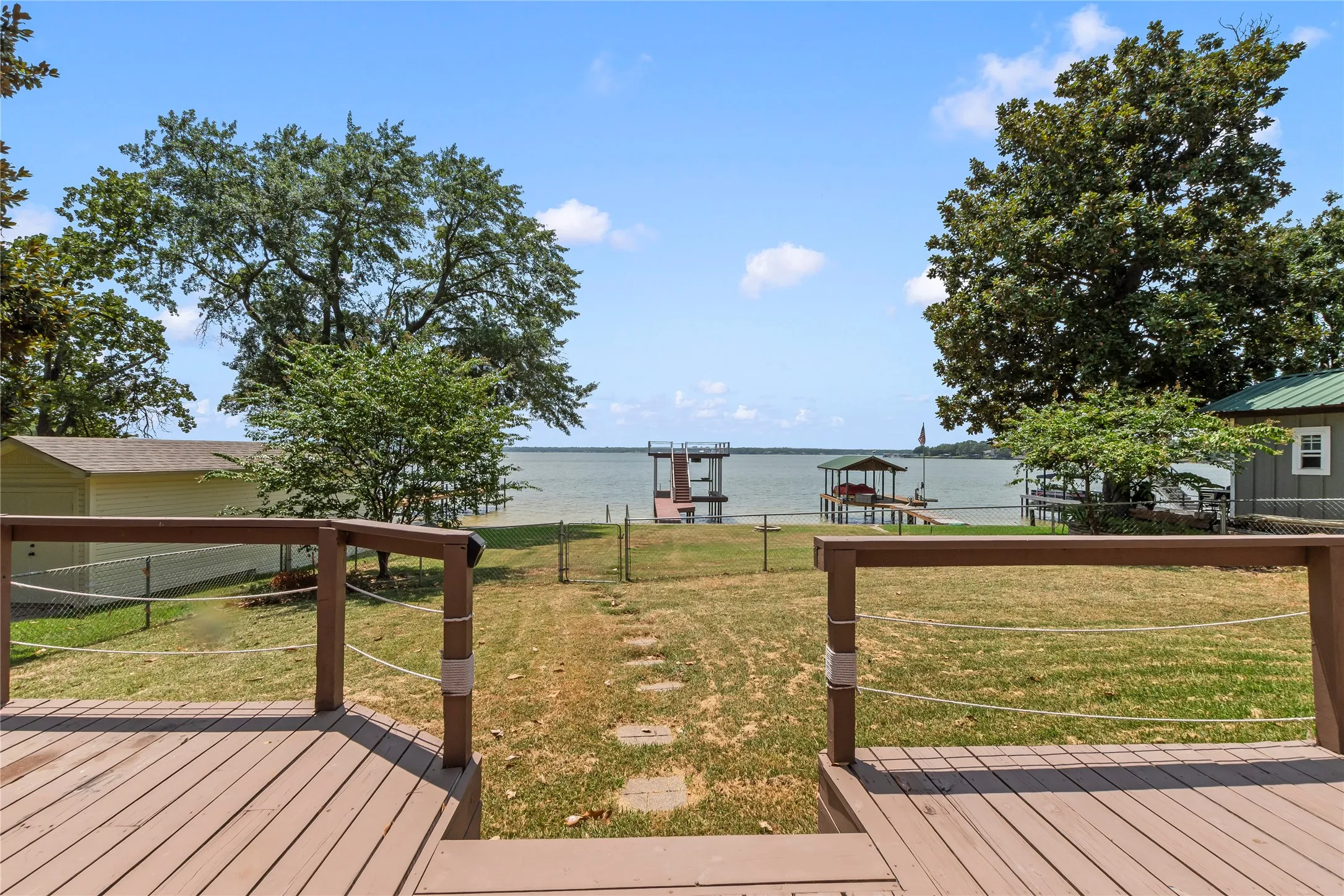 Open water views from the back deck overlooking the spacious, fenced backyard.