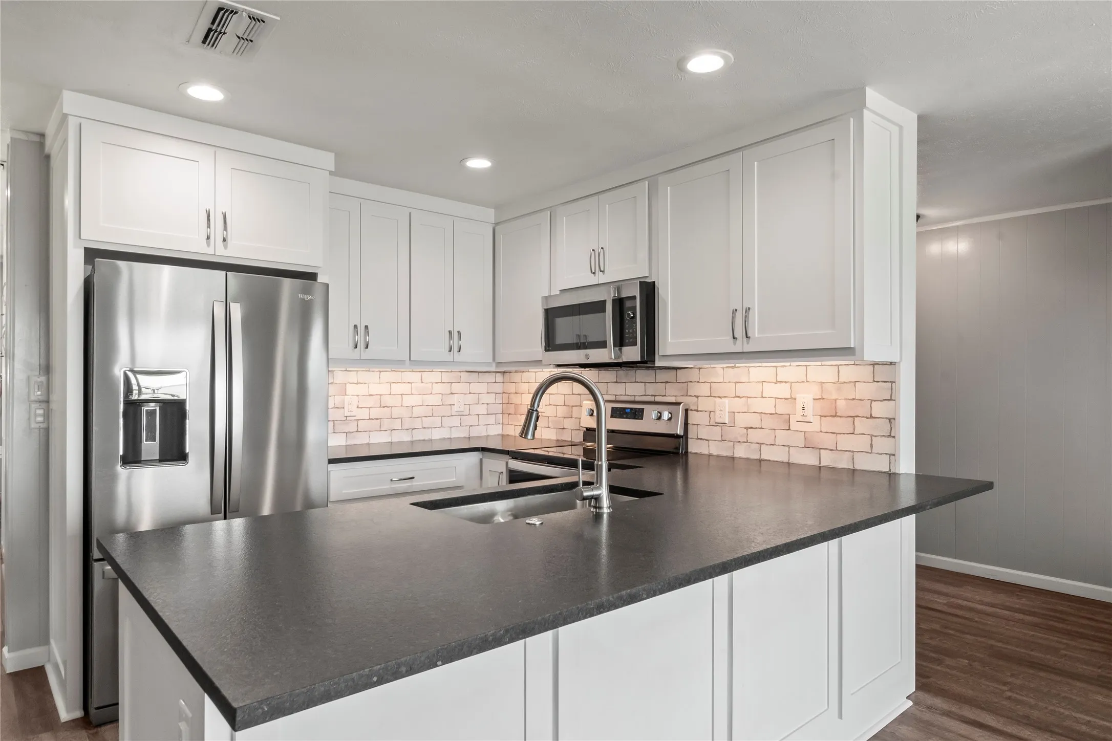 Oversized kitchen island creates the perfect space for meal prep and seating for casual dining.