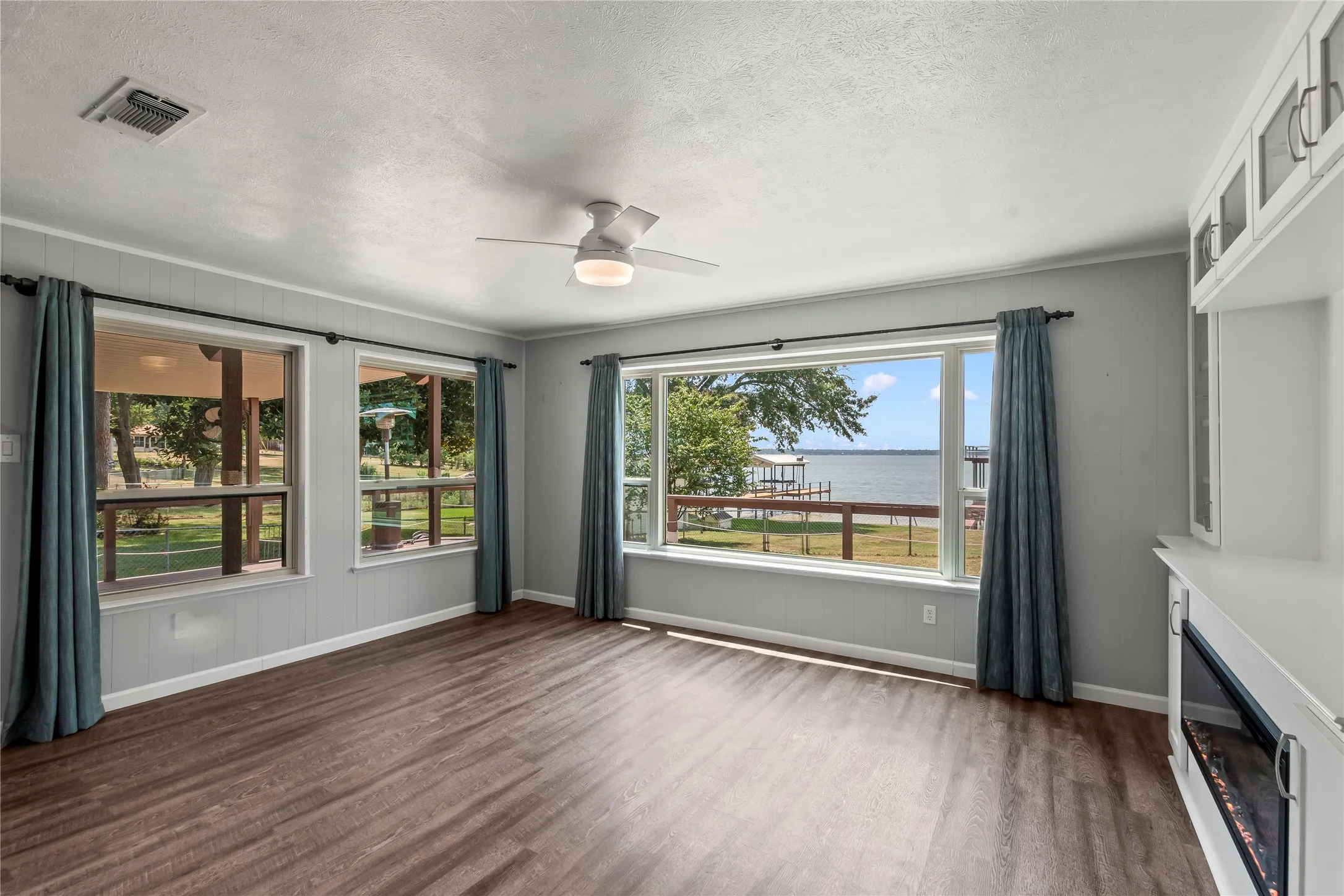 Spacious living room filled with natural light and fabulous open water views.