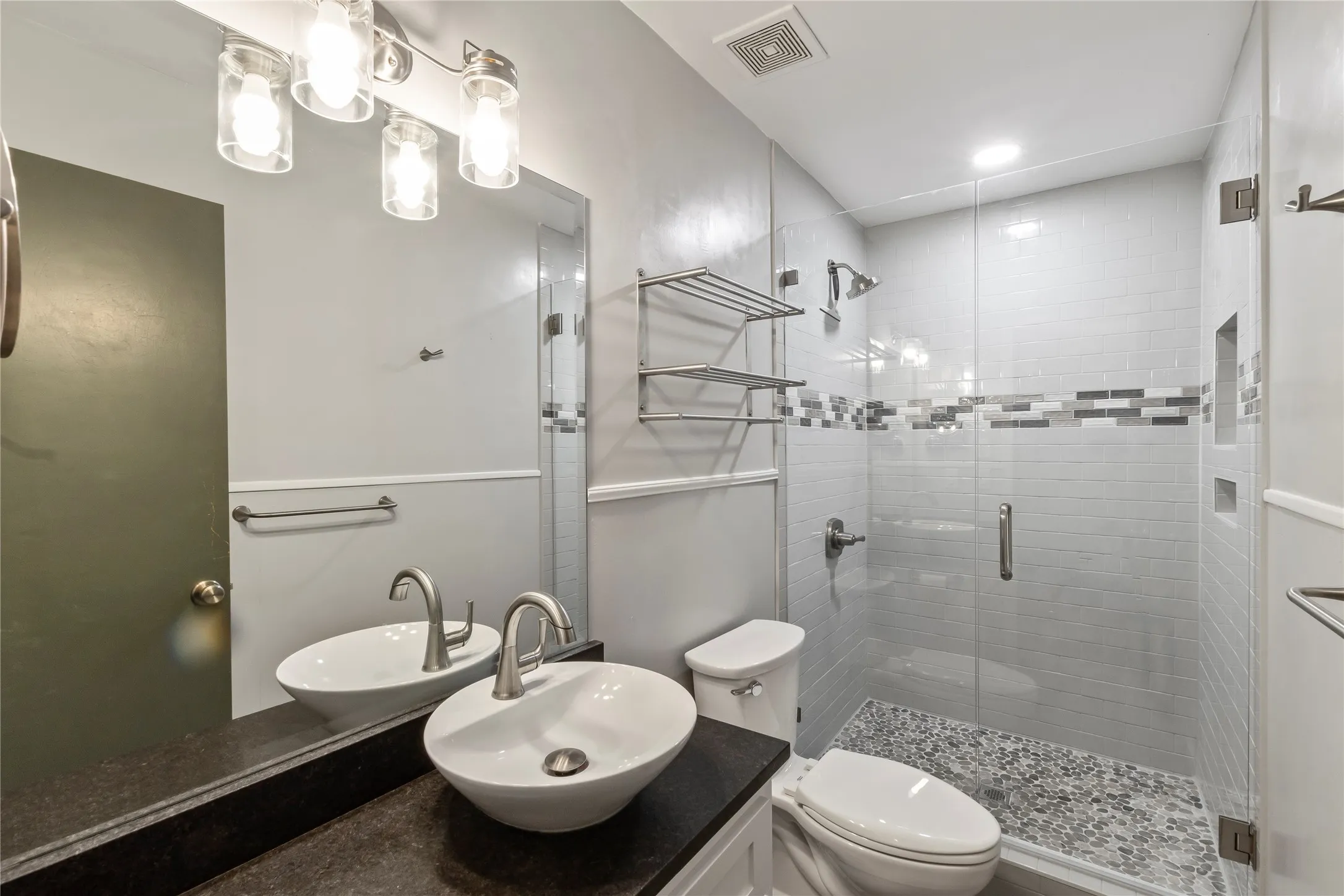 Fully remodeled bathroom featuring a walk-in tile shower and black leather granite countertop.