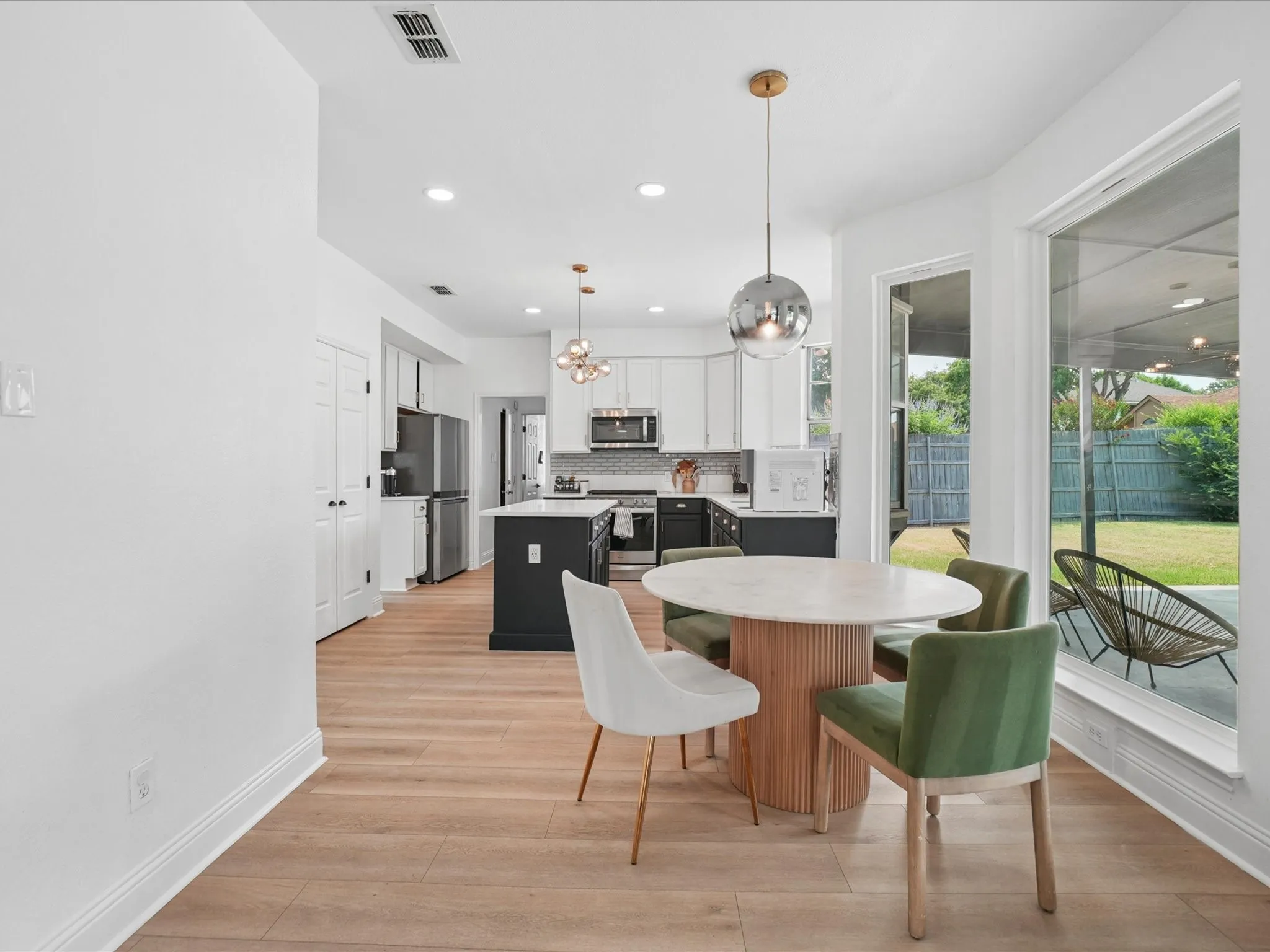 Open-concept living area featuring wood-finish flooring and recessed lighting