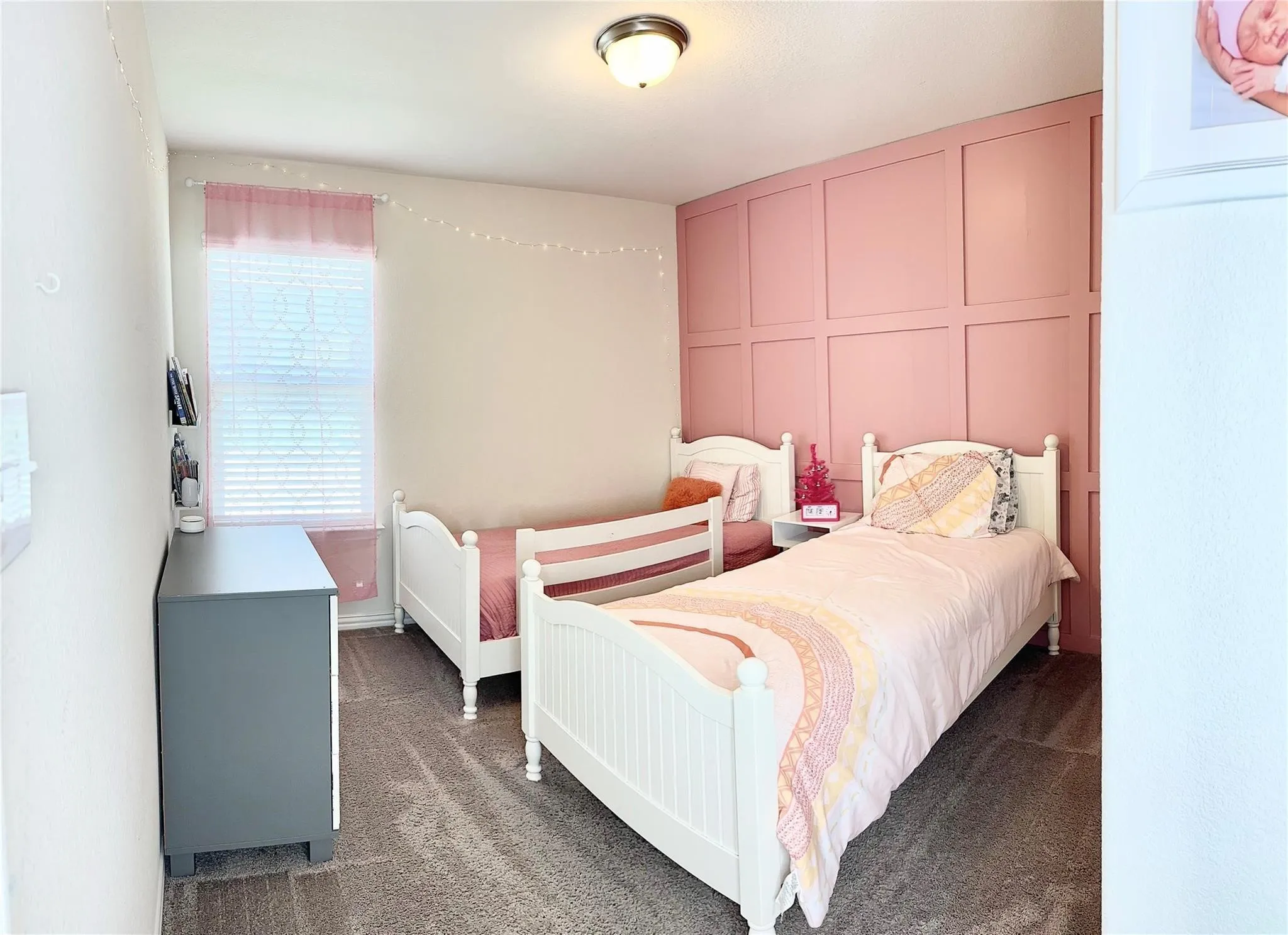 Bedroom 4 with designer accent wall featuring custom geometric panel molding that adds texture, dimension, and modern architectural appeal."