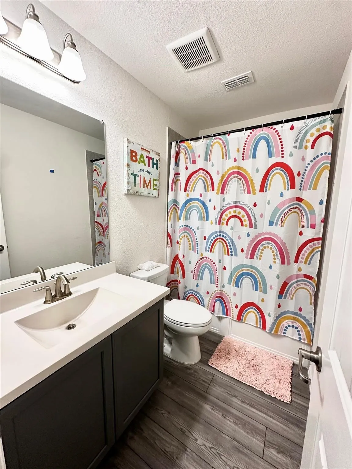 Bright secondary full bathroom featuring a generous vanity, contemporary finishes, and convenient access to nearby bedrooms.