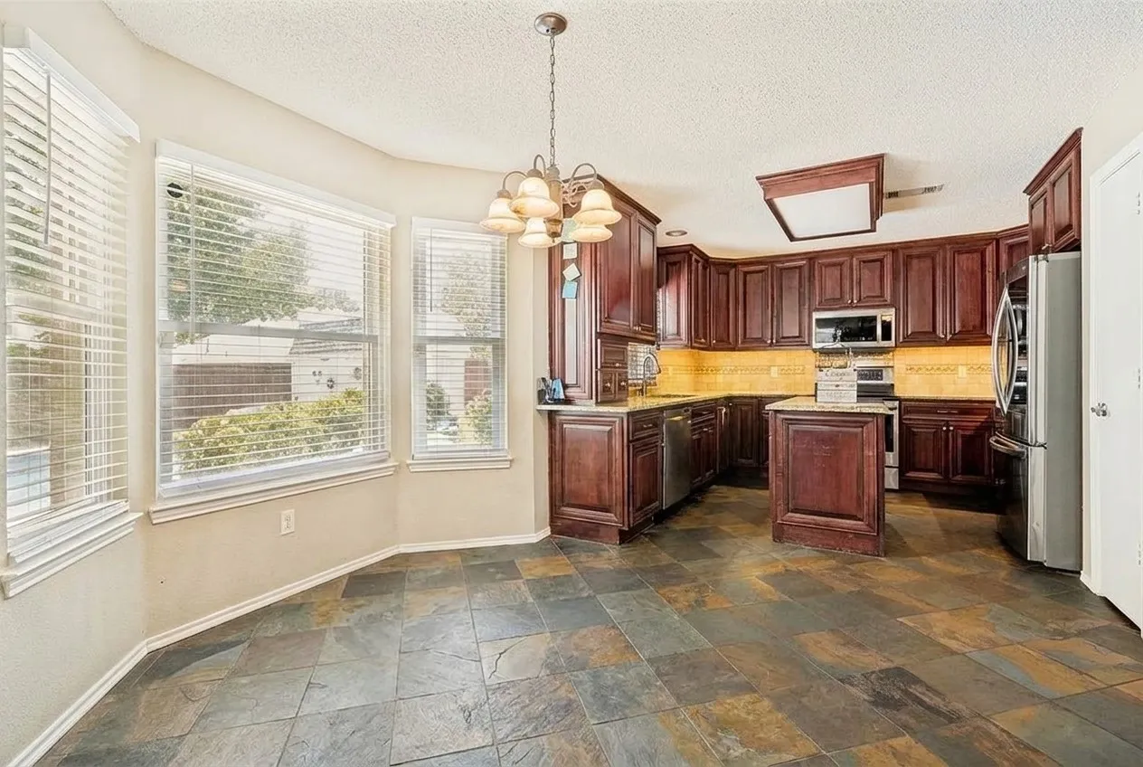 An abundance of windows fills the space with natural light while offering beautiful views of the pool, creating a bright, airy, and inviting atmosphere.