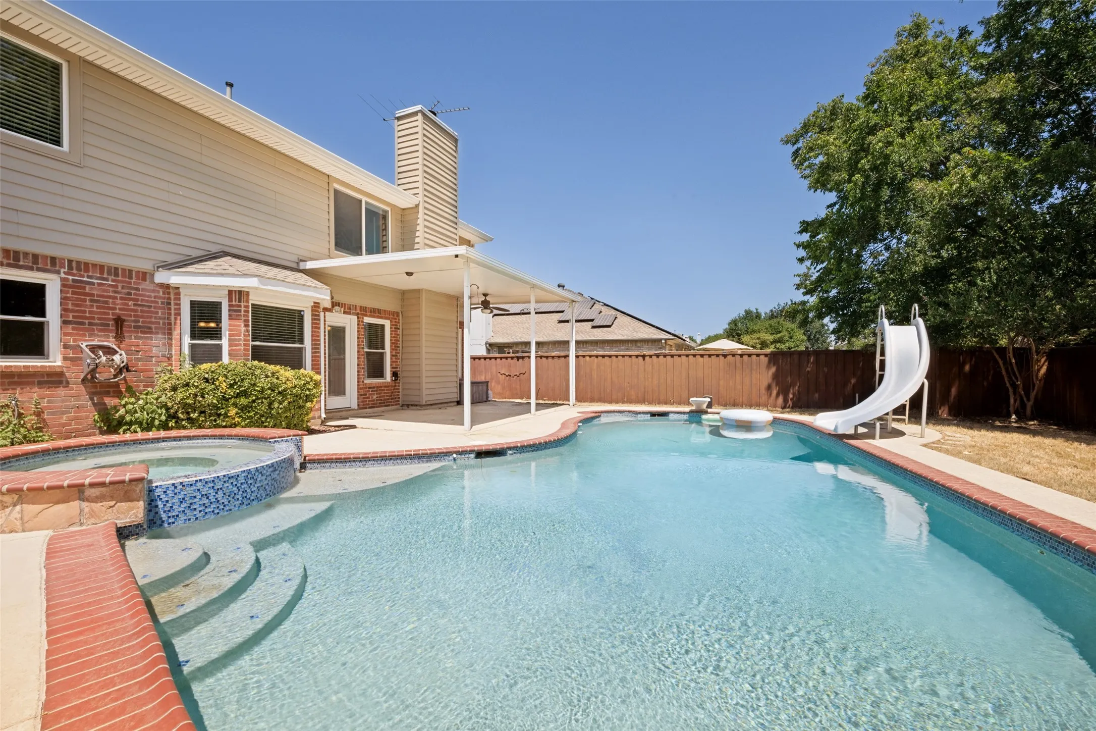 Recently replastered pool and spa complemented by a cool deck and non-slip coping, offering added comfort, safety, and convenience for enjoying the backyard oasis.
