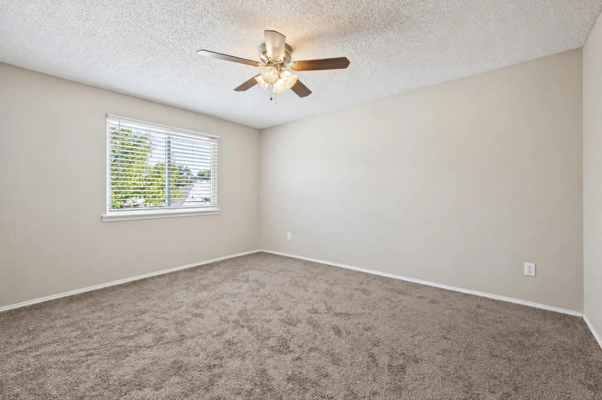 Generously sized secondary bedroom offering plenty of room for the kids to sleep, play, and make the space their own.