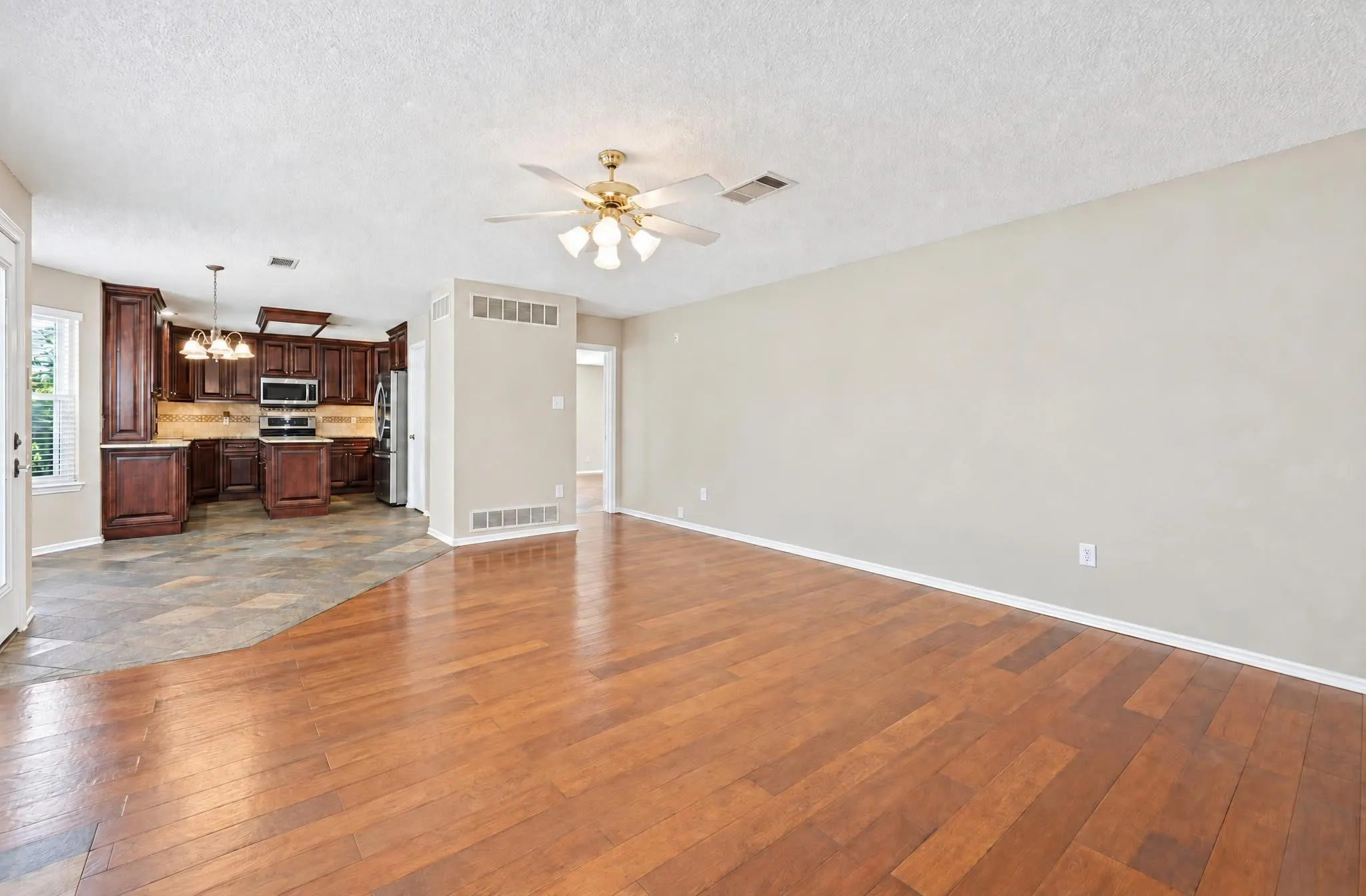 Warm and inviting living area featuring a beautiful fireplace and picturesque views of the pool, creating the perfect setting for relaxing or entertaining.