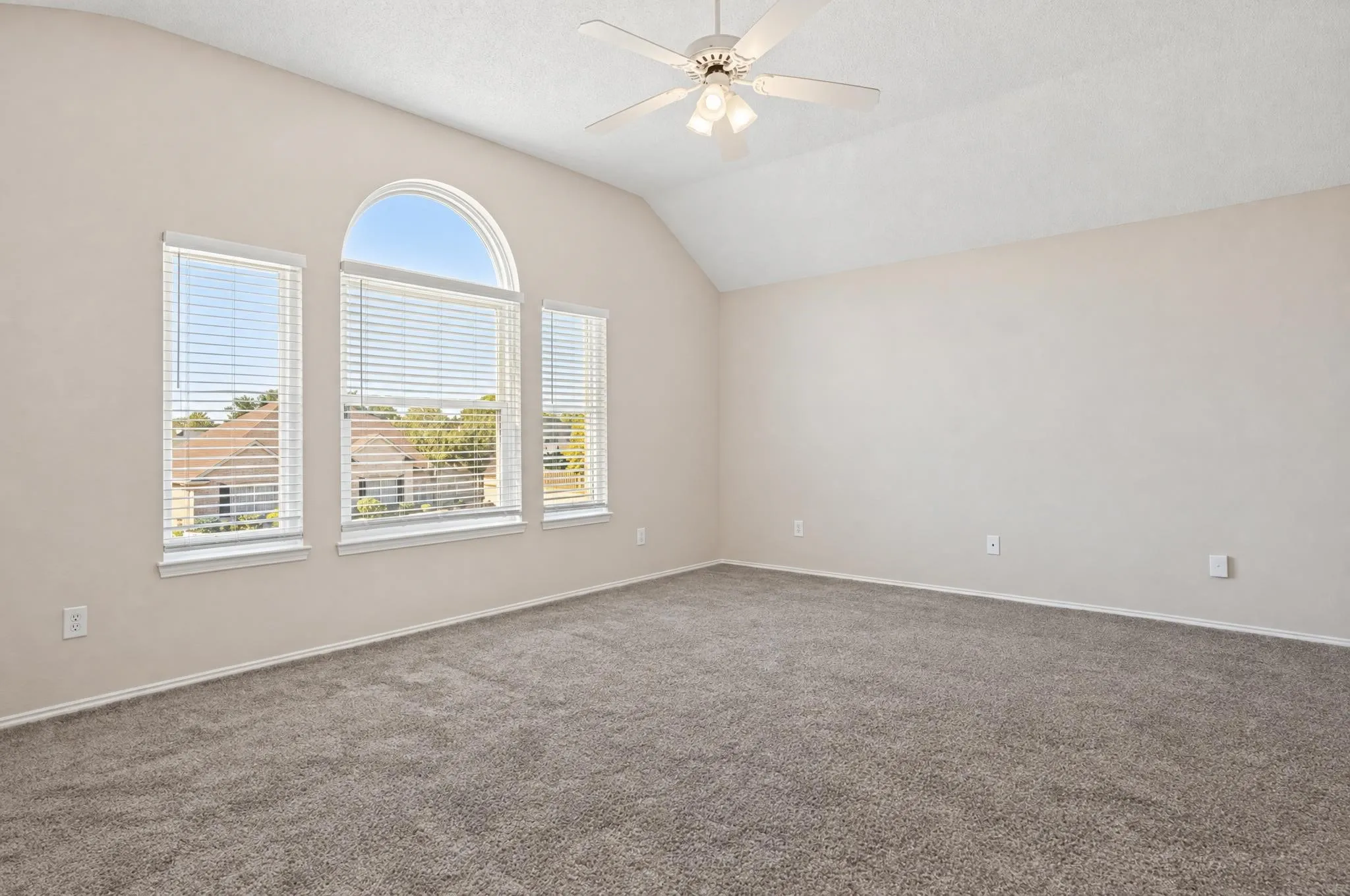 Spacious primary bedroom filled with natural light and thoughtfully designed with comfortable sitting area, creating a peaceful retreat to relax and unwind.