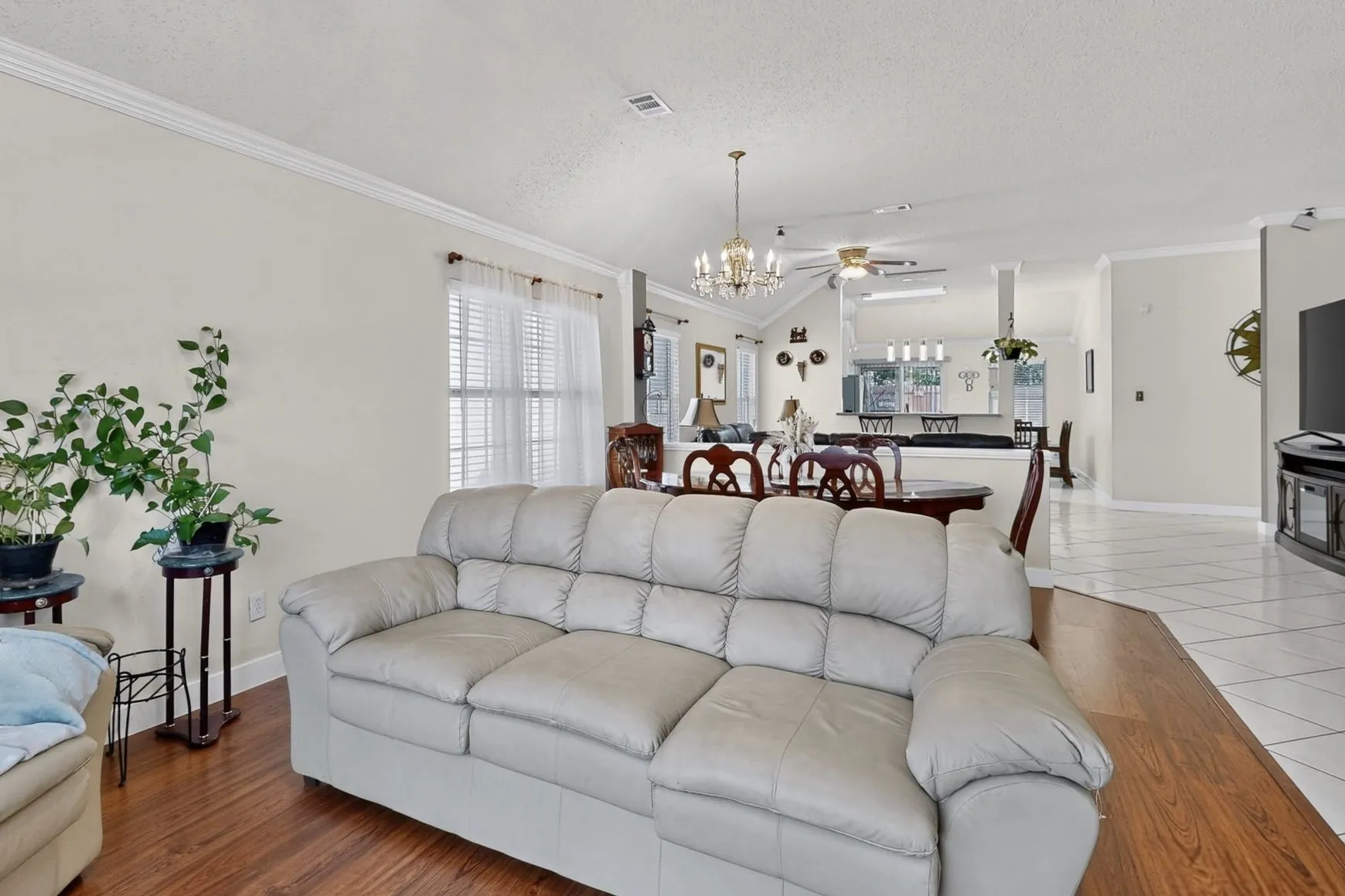 Open concept living area featuring wood-finish flooring and a vaulted ceiling