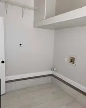 Spacious Utility Room with Storage Area & a Door to the Deck