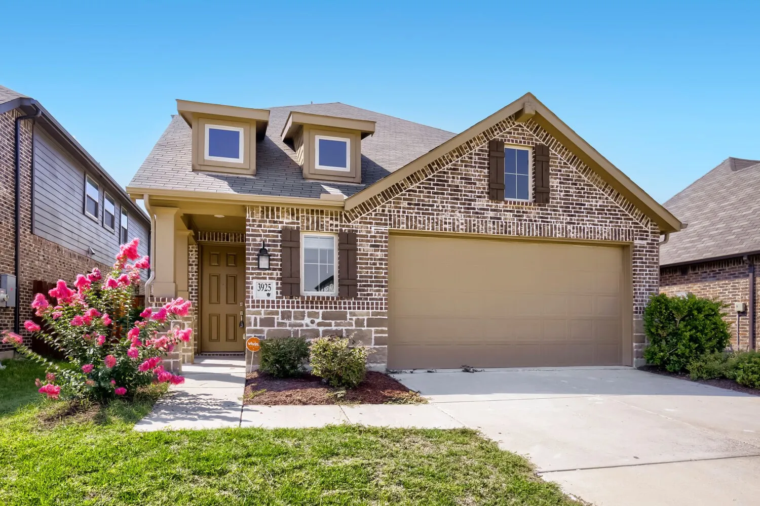 Brick and stone exterior with decorative gable detailing and arched entryway