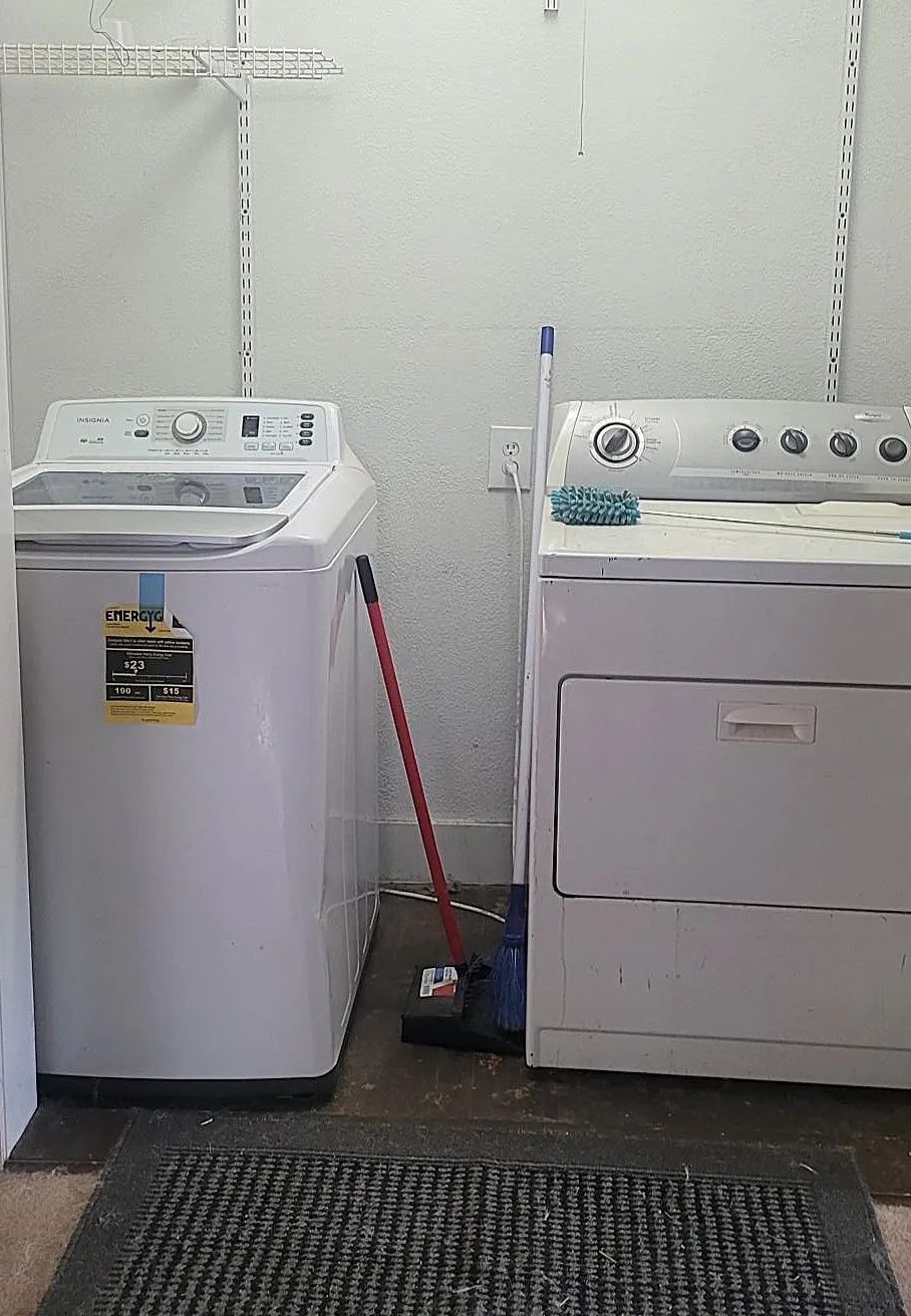 Laundry area featuring white walls and a white wire shelving system