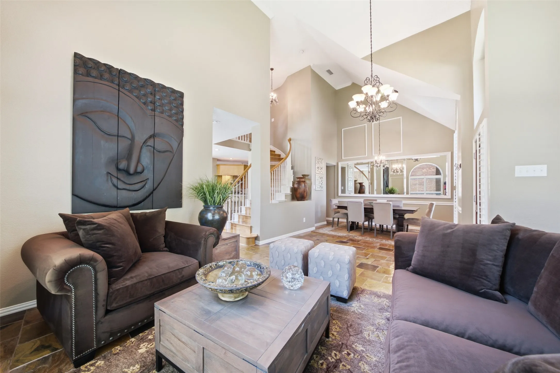 Formal living room with dramatic vaulted ceilings, and an open view into the dining room — an ideal space for elegant entertaining.