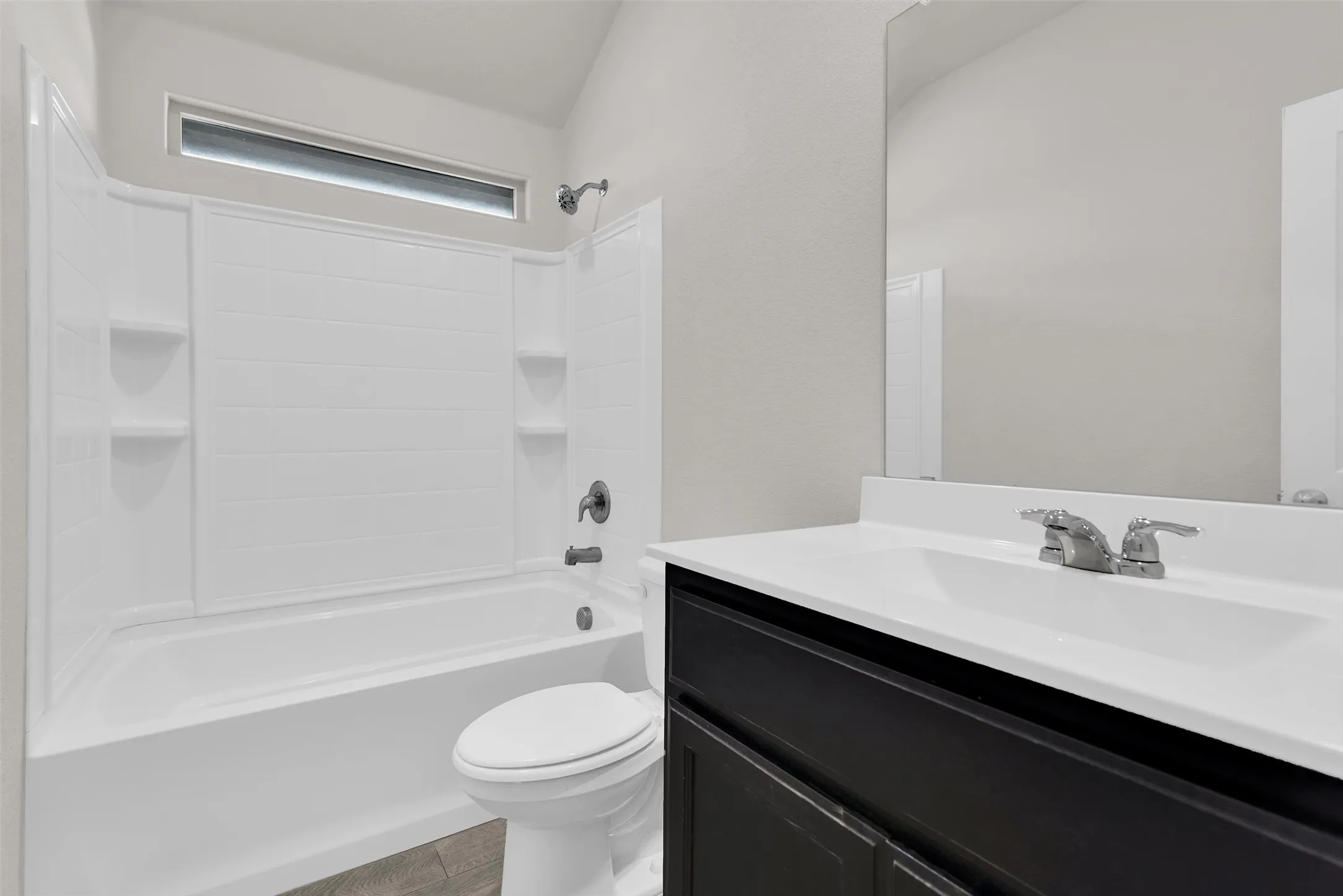 White tub and shower combination with integrated shelving