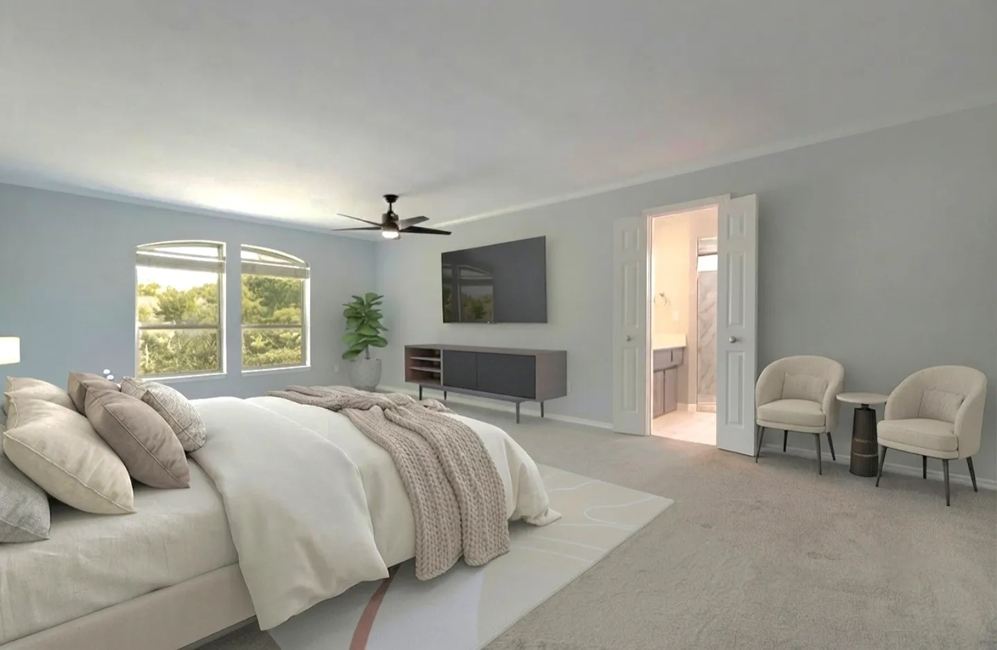 This serene primary bedroom offers generous space that easily accommodates a sitting area, creating a comfortable retreat within the home. The pair of arched windows adds architectural elegance while bringing in soft, natural light and peaceful views of the greenery outside. The room features light, neutral carpeting and walls that enhance the bright, calming atmosphere. Double doors open directly into the private ensuite bathroom, highlighting the room’s convenience and privacy. With its spacious layout, refined details, and dedicated full bath, this primary suite delivers both comfort and sophistication.