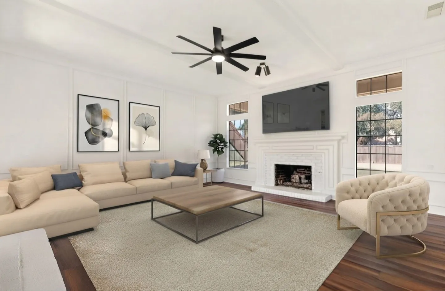 This beautiful room is anchored by a white brick fireplace that immediately draws the eye and adds a striking focal point to the space. The surrounding paneled walls create a refined, architectural backdrop that elevates the room’s character. Tall windows on each side of the fireplace bring in balanced natural light and frame peaceful views of the greenery outside, enhancing the room’s symmetry and charm. The dark flooring adds depth and contrast, while the modern ceiling fan and lighting complete the clean, polished presentation. This space offers a standout feature wall that enhances the home’s overall appeal and creates a warm, inviting atmosphere.