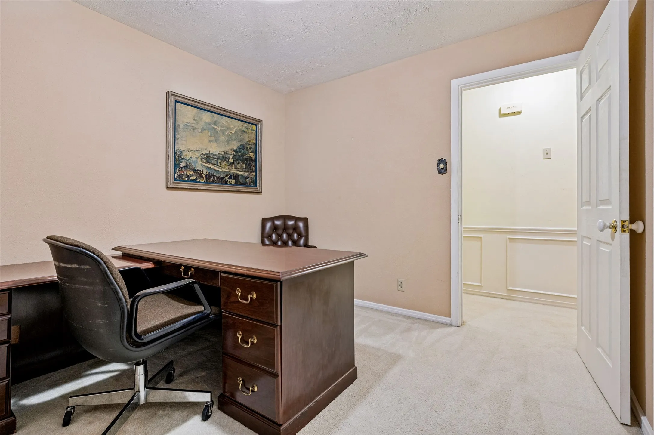 Carpeted room with neutral wall color and white trim
