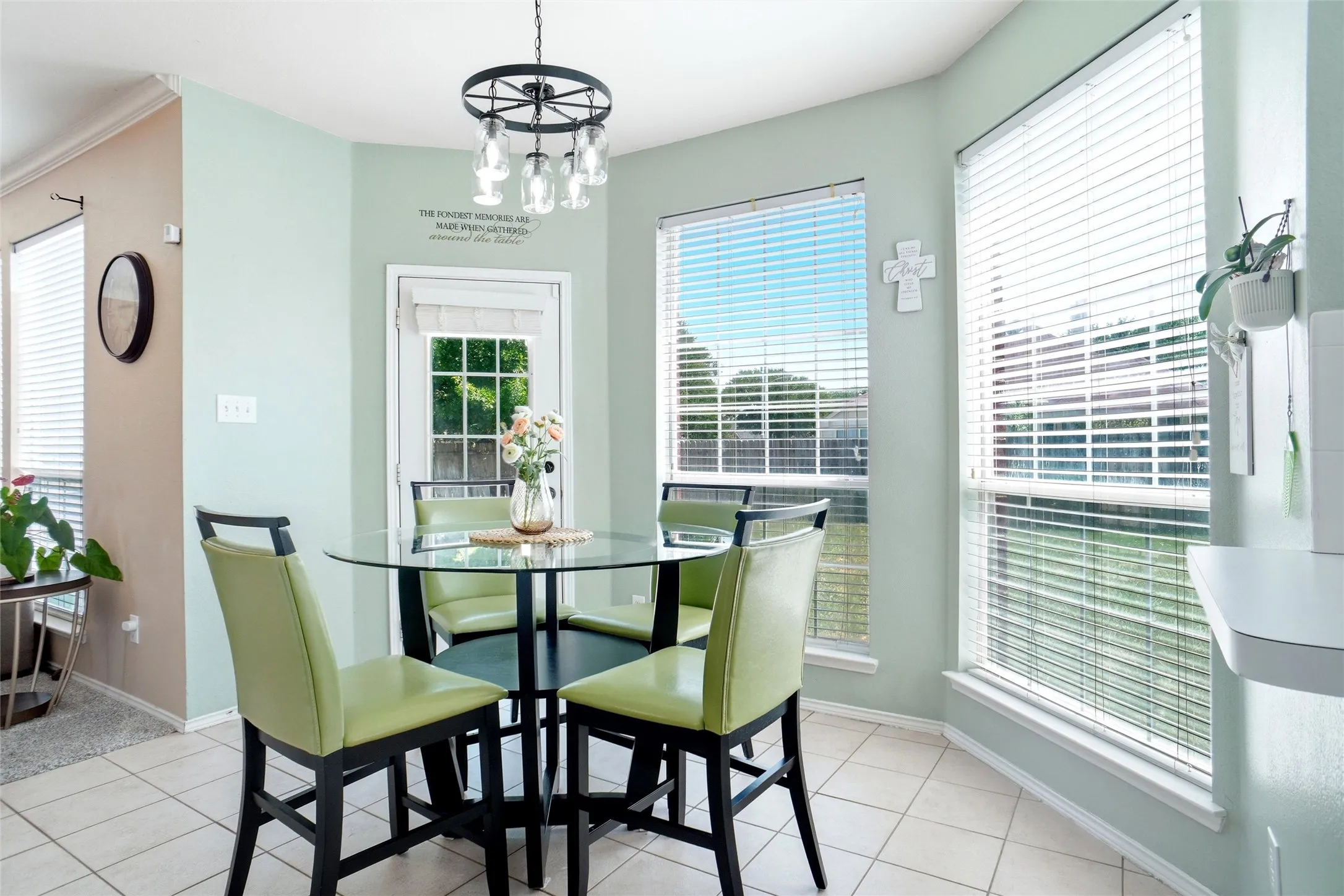 Sunny breakfast area surrounded by large windows, offering abundant natural light and direct access to the backyard.