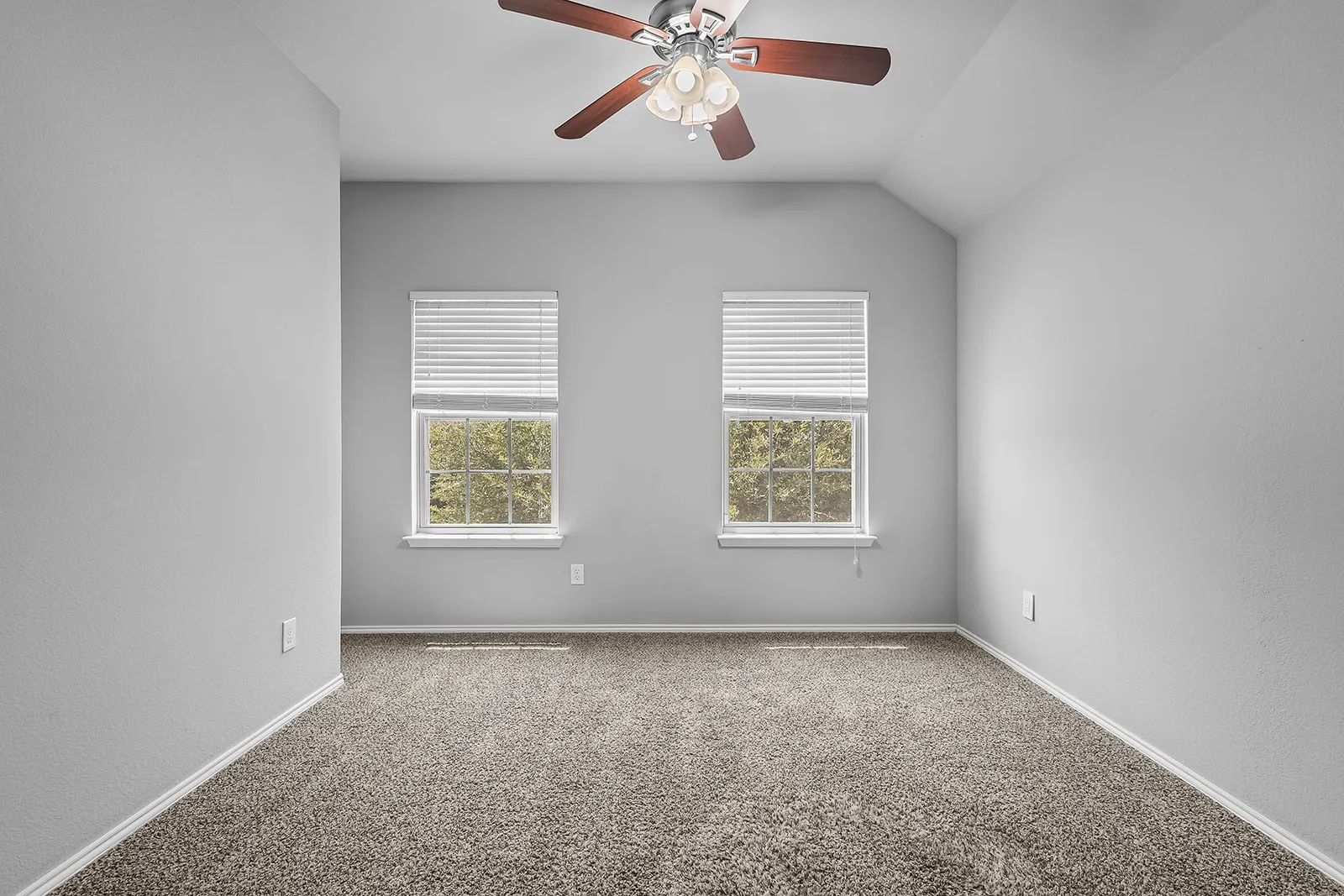 Neutral-toned walls complement the textured carpet flooring