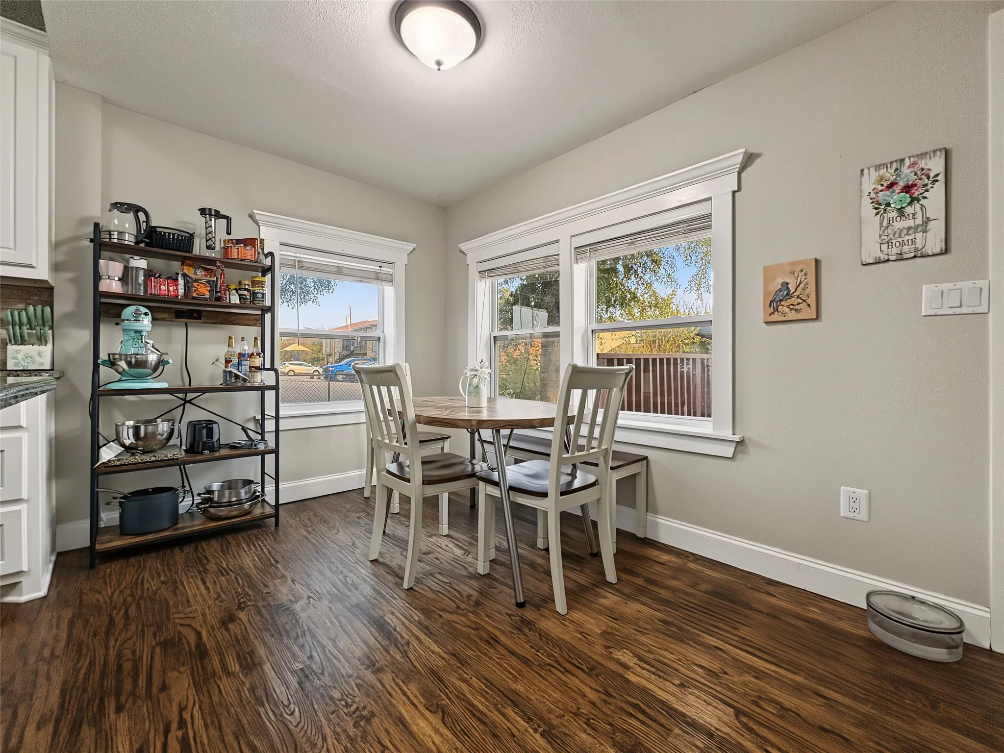 Wood-finish flooring throughout, complemented by light gray wall paint and white trim