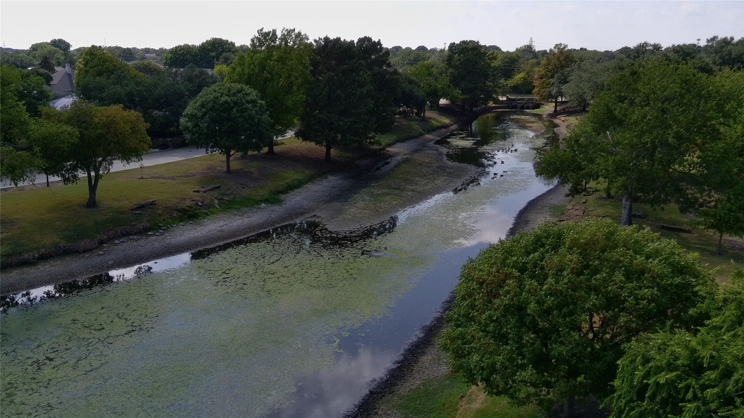 Aerial view of the private pond and footbridge across from the home